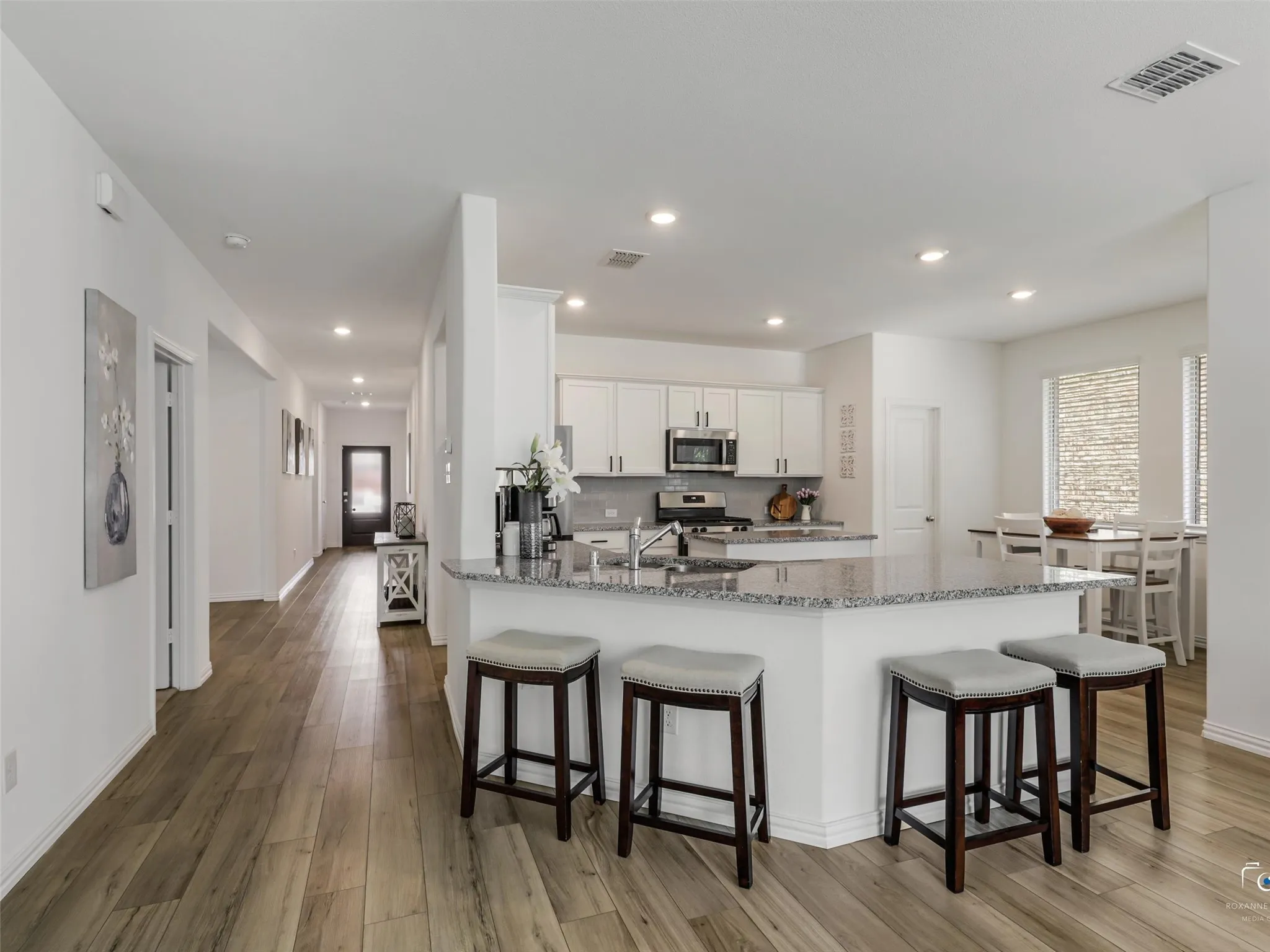 The breakfast bar make dinner hour a breeze, opens to Living Room