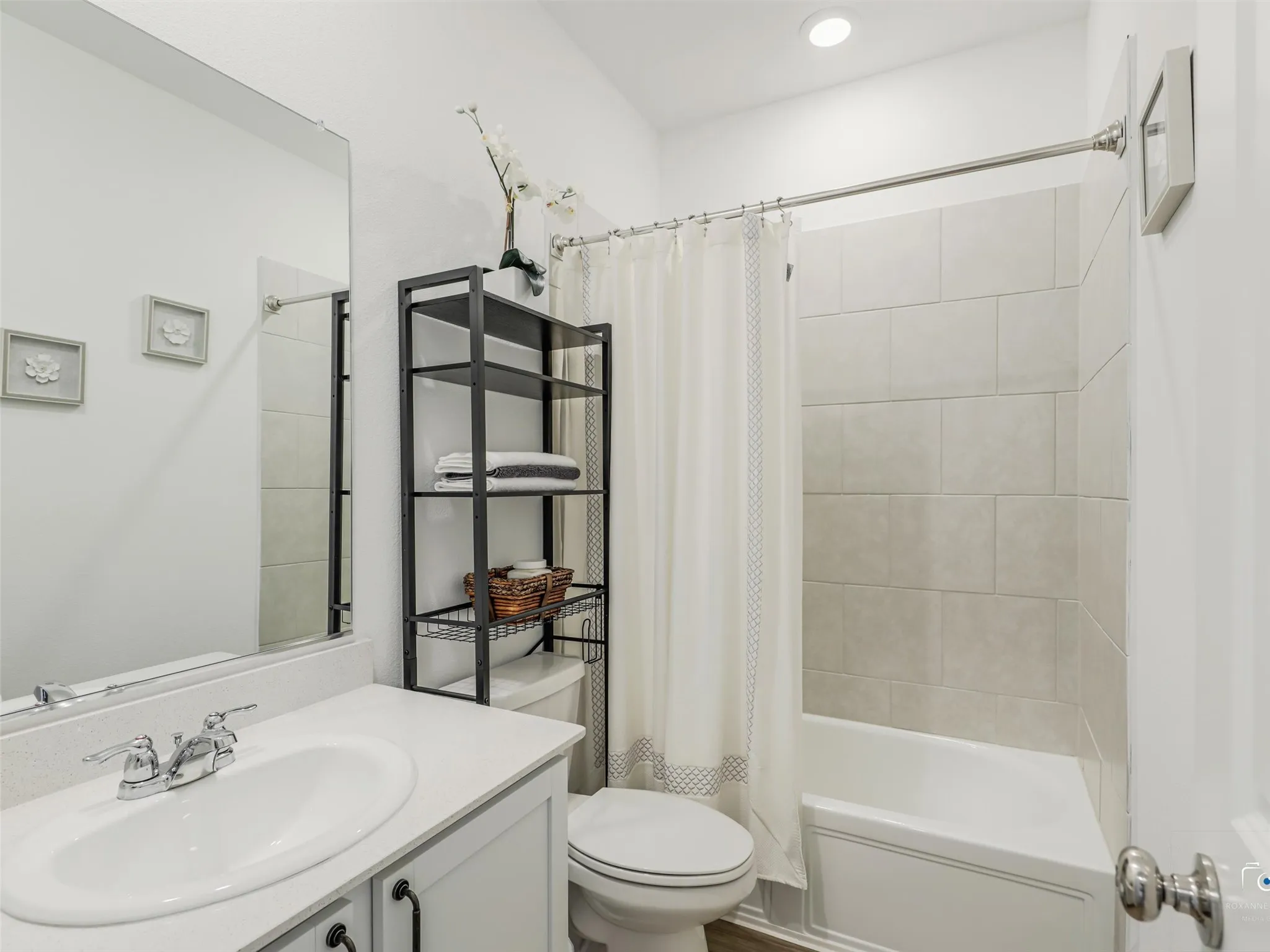 Full Bathroom with shower tub combo located next to secondary bedrooms