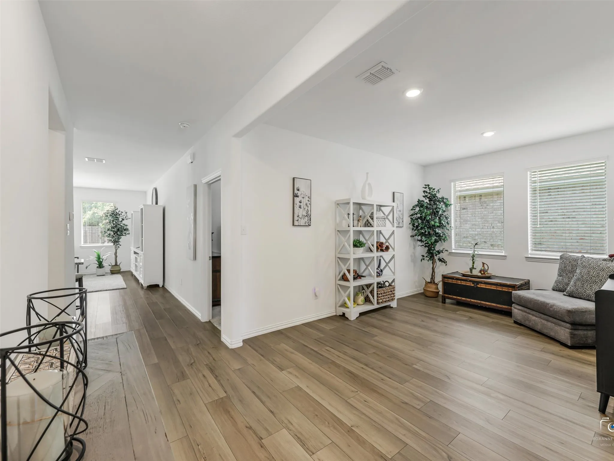 Across from the Dining Room/flex space is the Kitchen, while the hallway leads on to the Living Room. The door to the Primary suite is the first door past this space