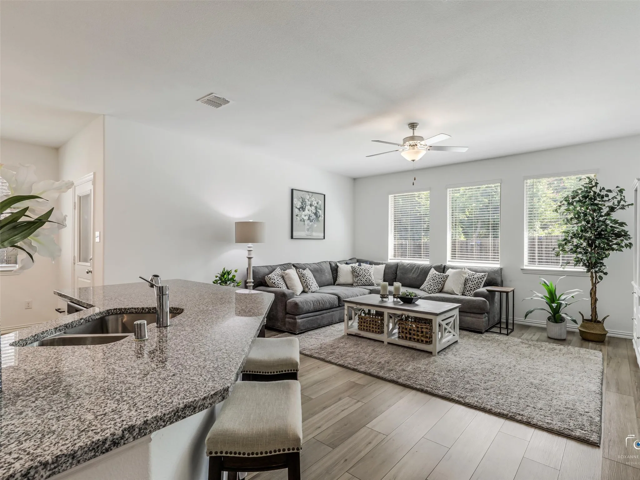 Light and bright Living Room is ideal for gathering. 2 inch Faux wood blinds adorn the windows