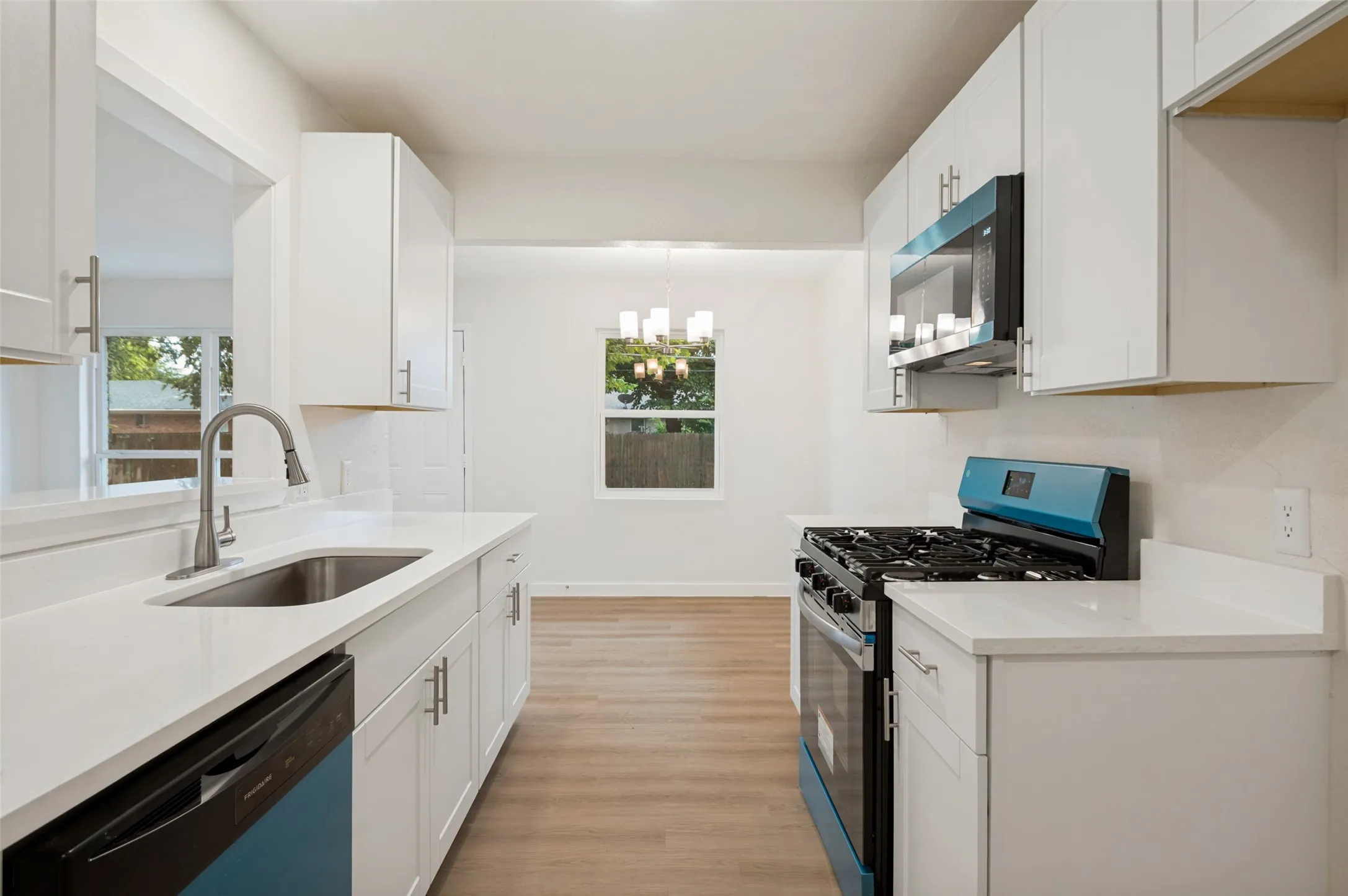 Kitchen view to dining area and yard