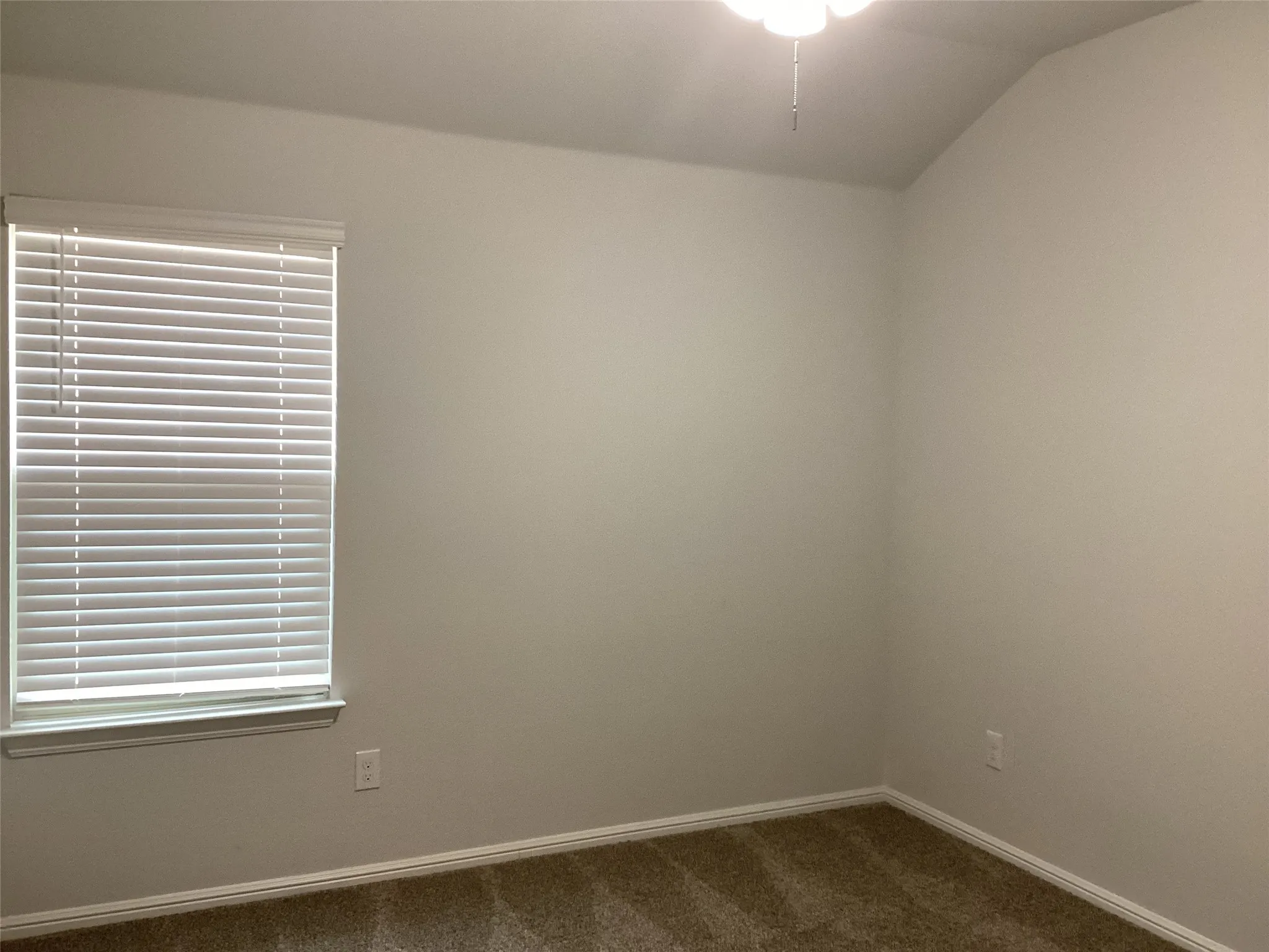 Neutral-toned interior with textured carpeting and baseboard molding
