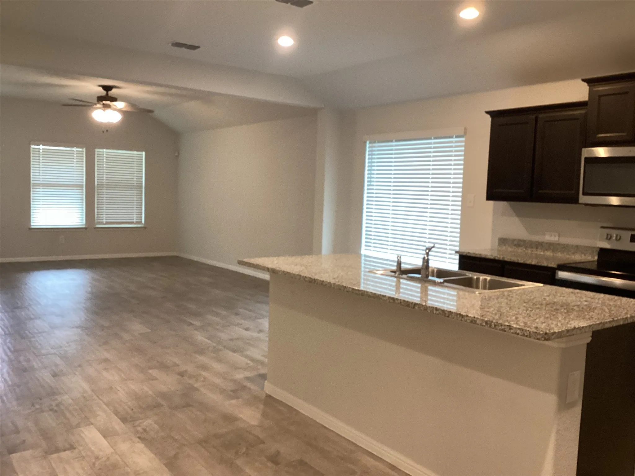 Open-concept interior featuring light wood-finish flooring throughout