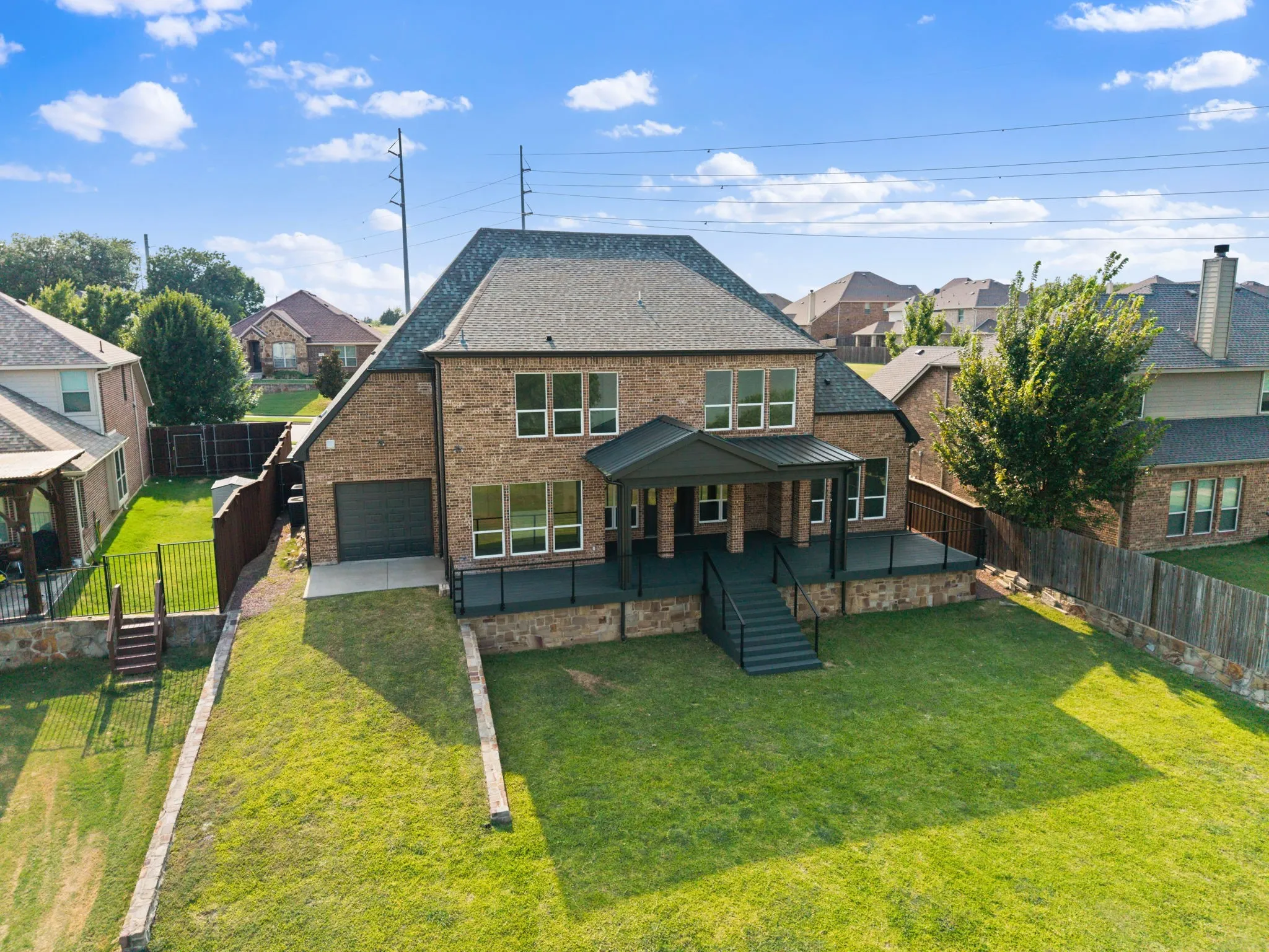 Stunning two-story brick residence with a sophisticated gabled roofline and multiple window banks
