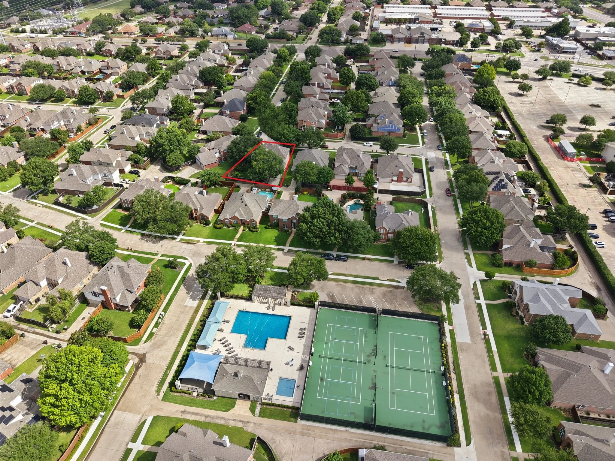 Aerial perspective highlighting a residential neighborhood with tree-lined streets
