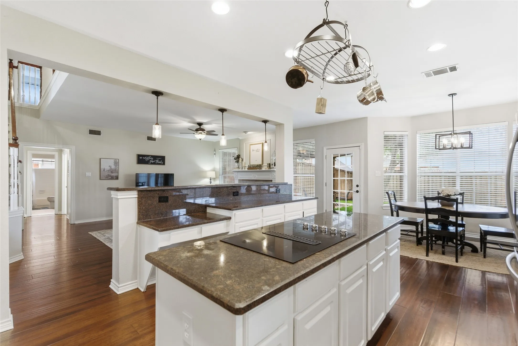 Kitchen island with integrated cooktop and stone-finish countertop