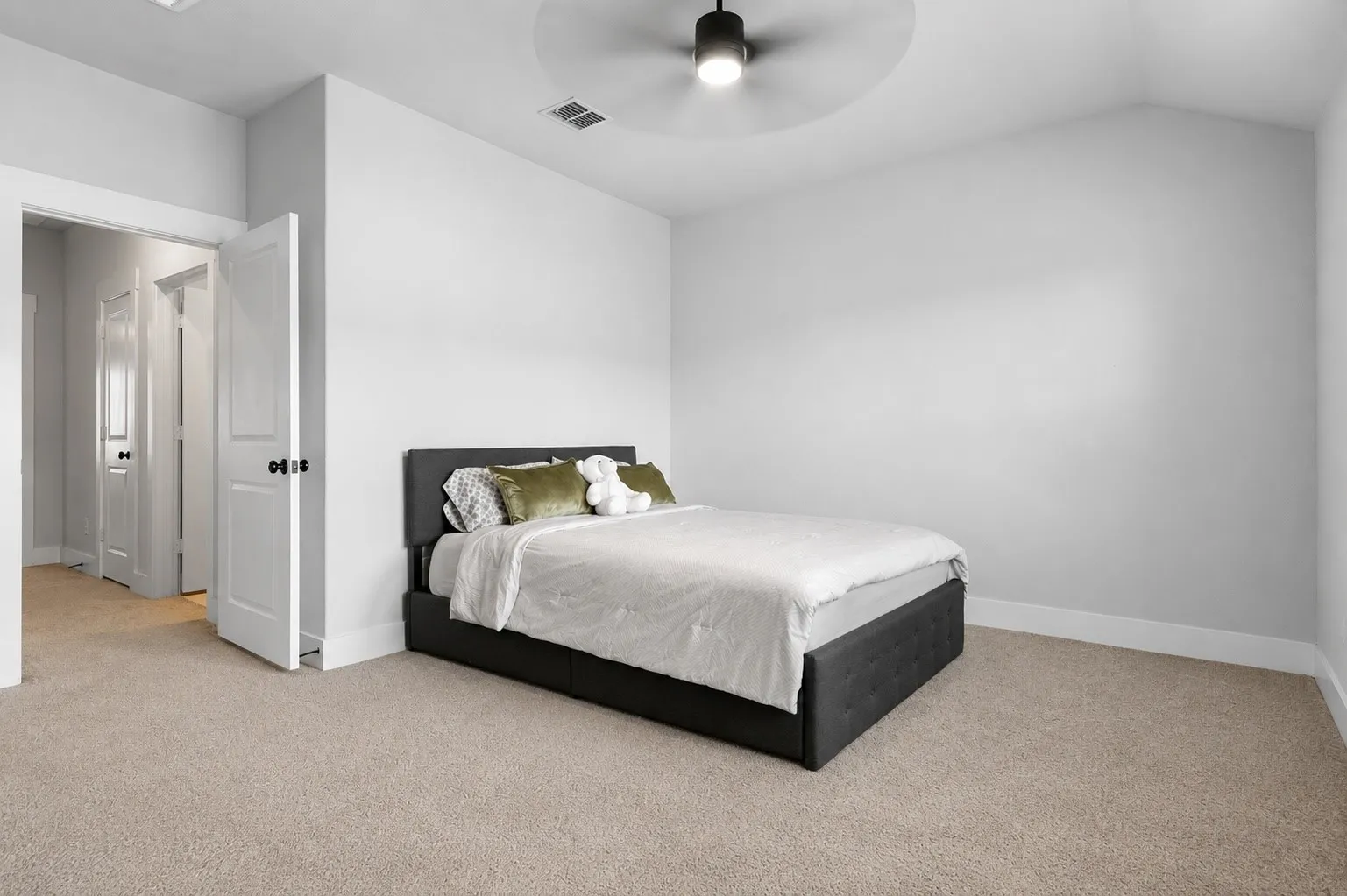 Bedroom 2 featuring vaulted ceiling, neutral wall paint, light carpet flooring, baseboard trim, and a ceiling fan with integrated​​‌​​​​‌​​‌‌​‌‌​​​‌‌​‌​‌​‌​​​‌​​ lighting