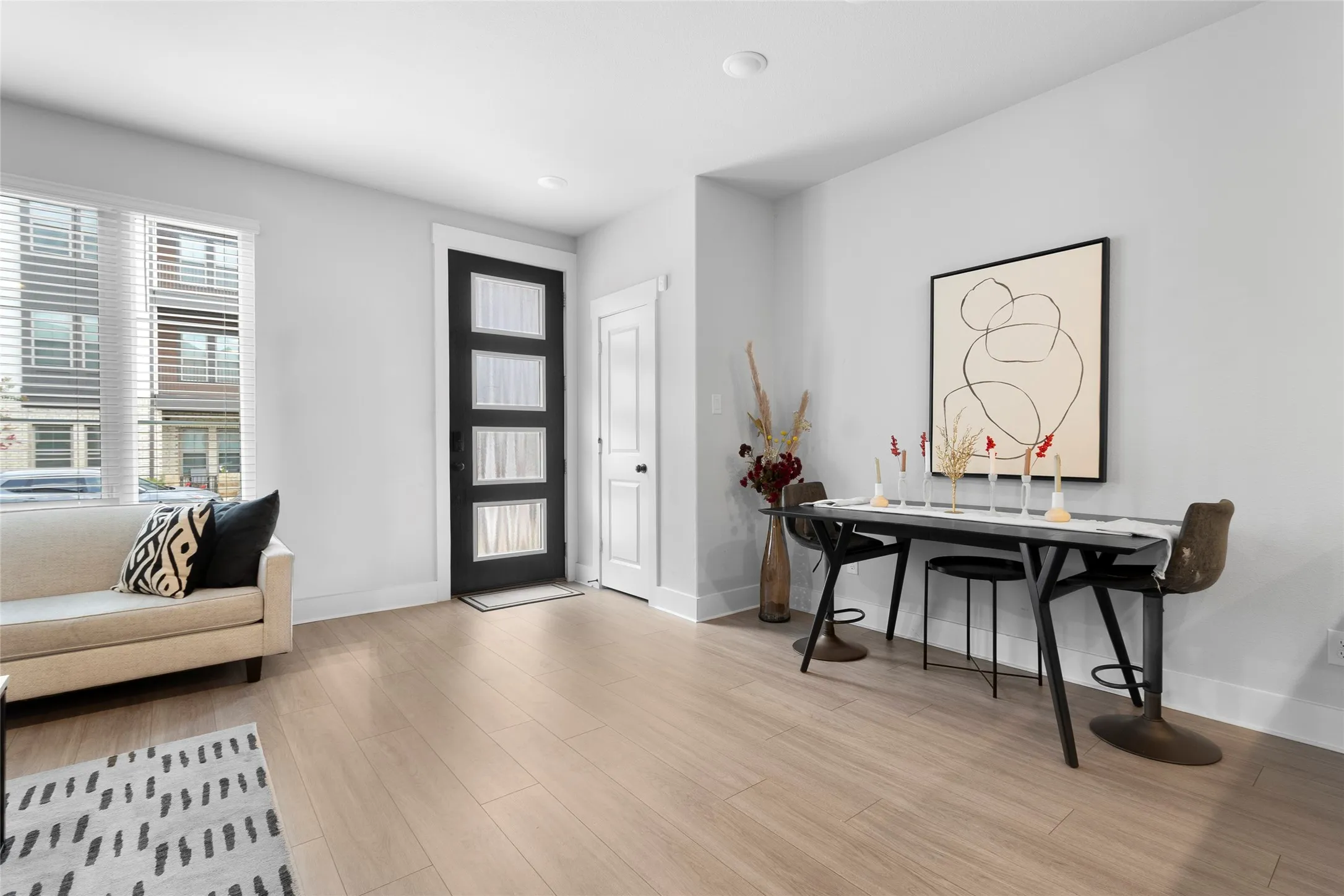 Light wood-finish flooring complements the bright interior