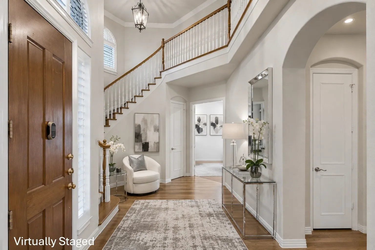 Two-story entrance with hardwood floors