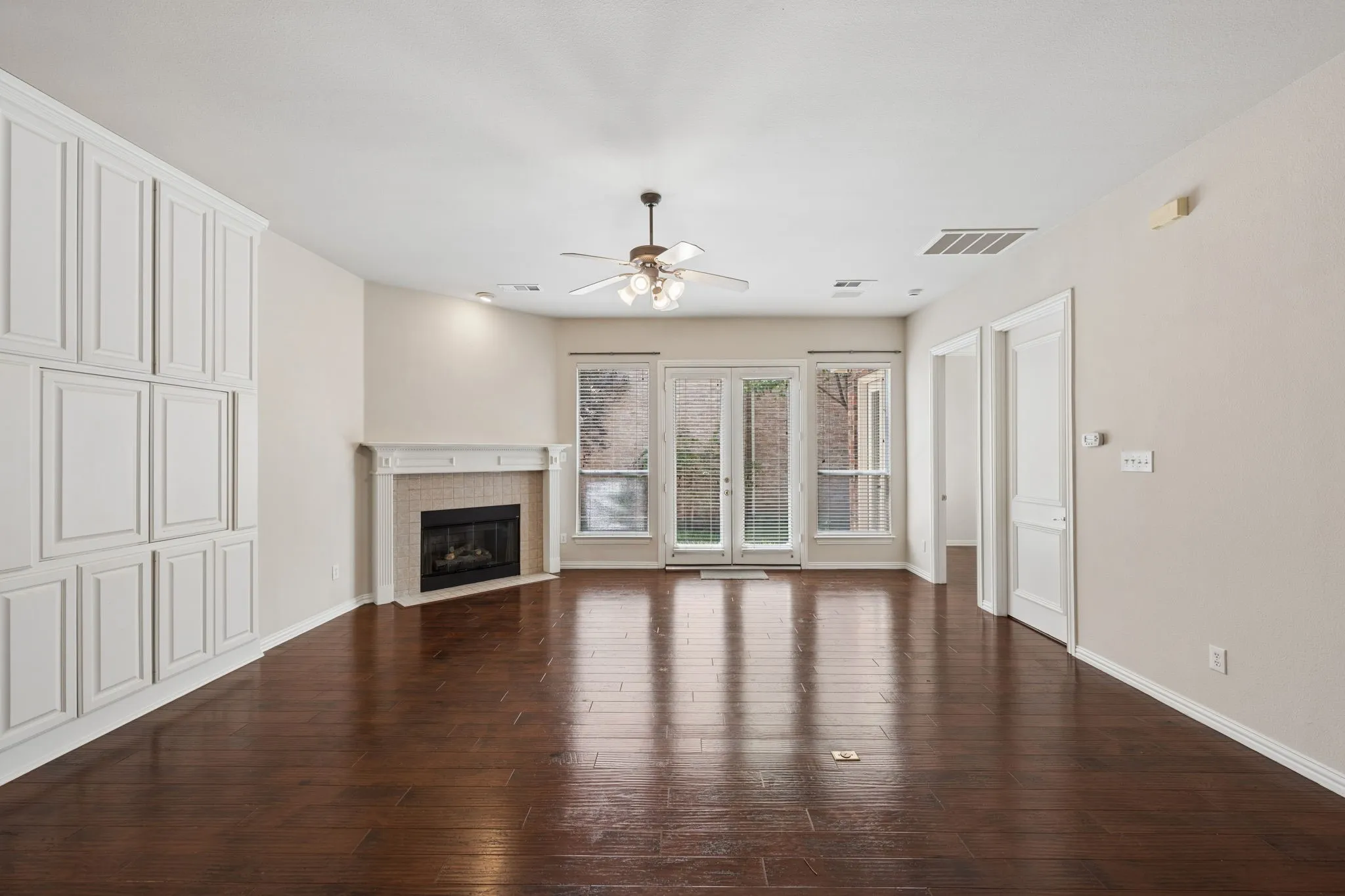 First floor living room with access to kitchen, primary bedroom and outside patio