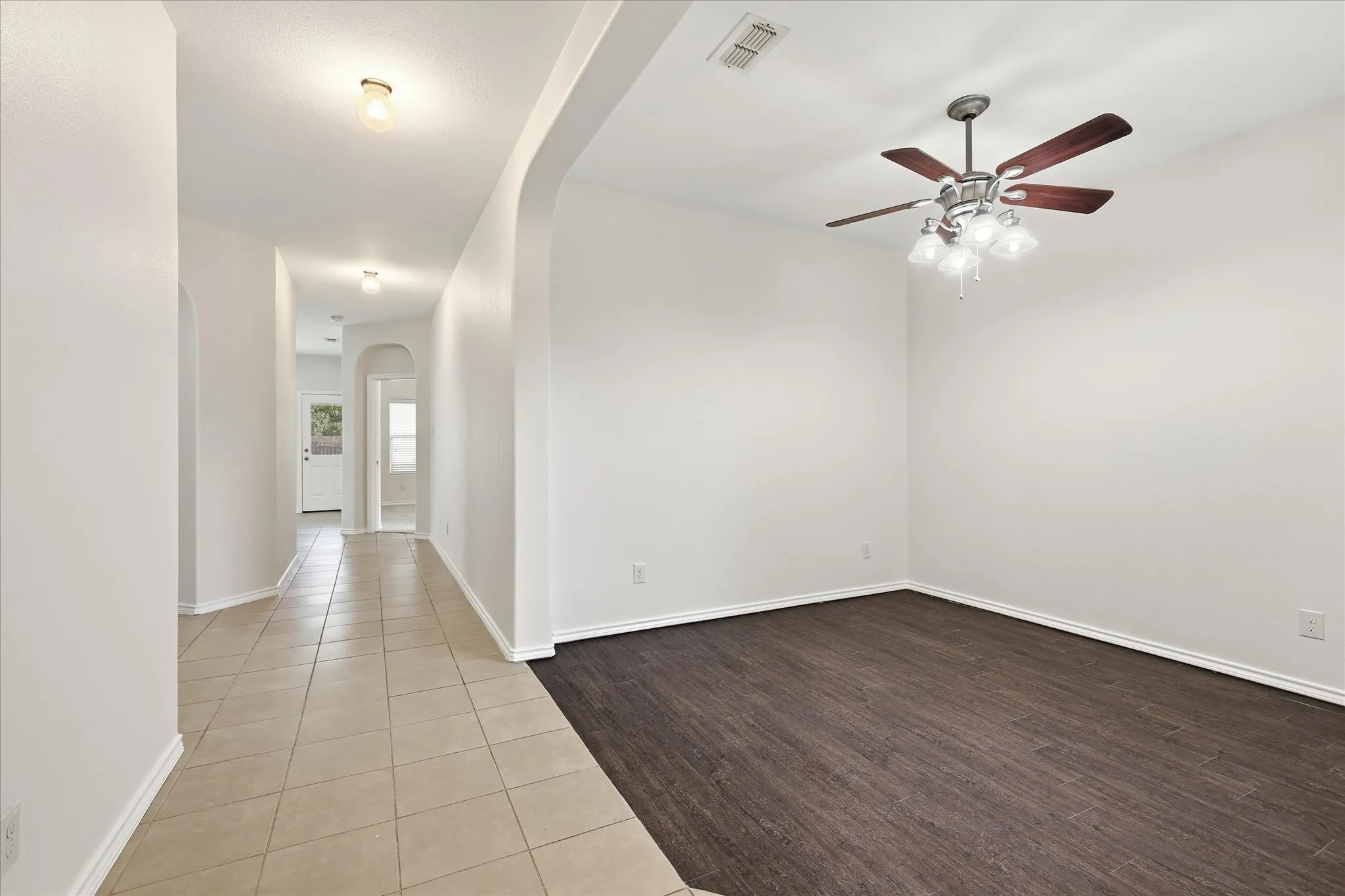 Entryway featuring neutral-toned tile flooring and arched doorways
