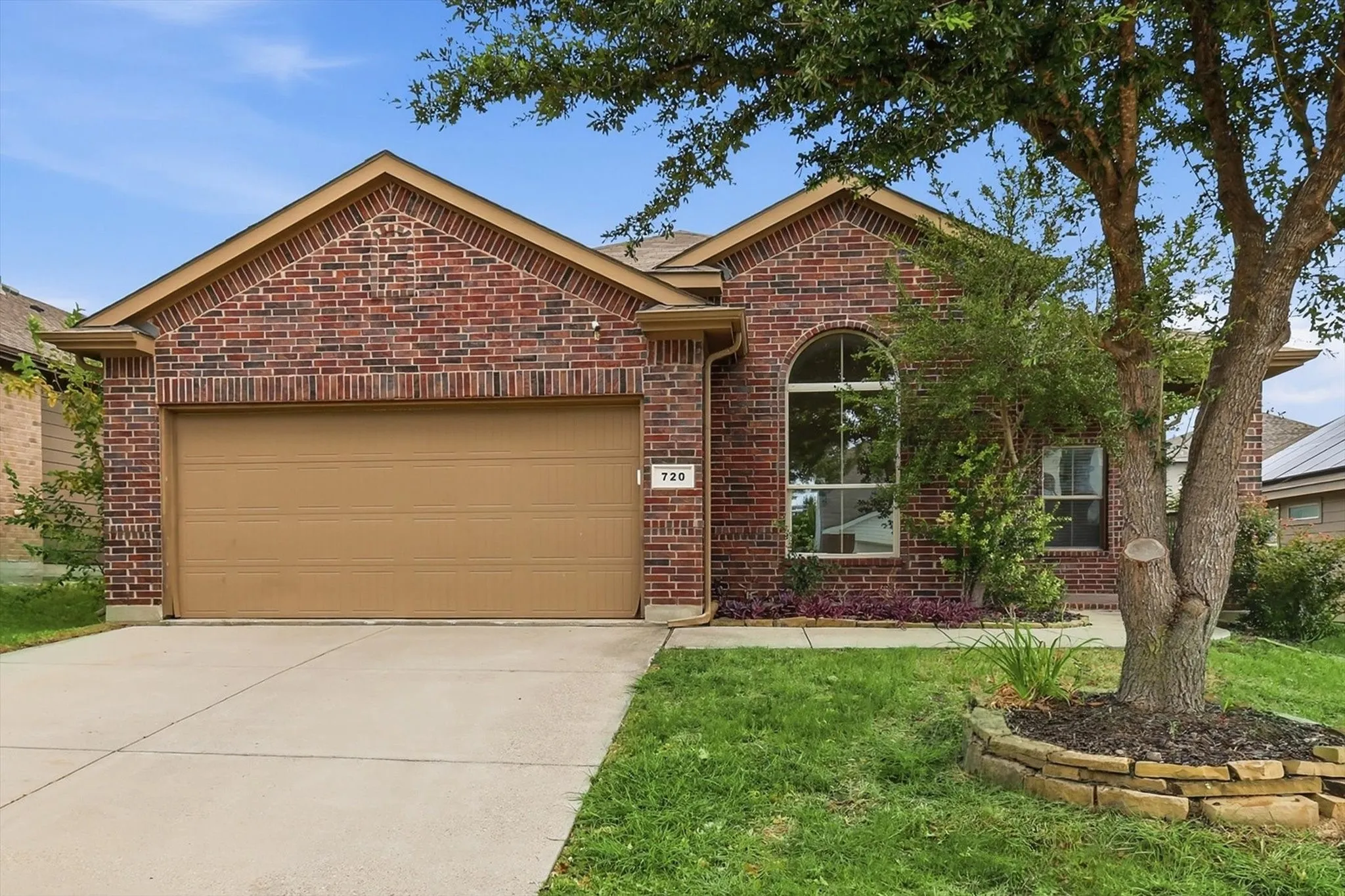 Brick exterior with a gabled roofline and an arched window