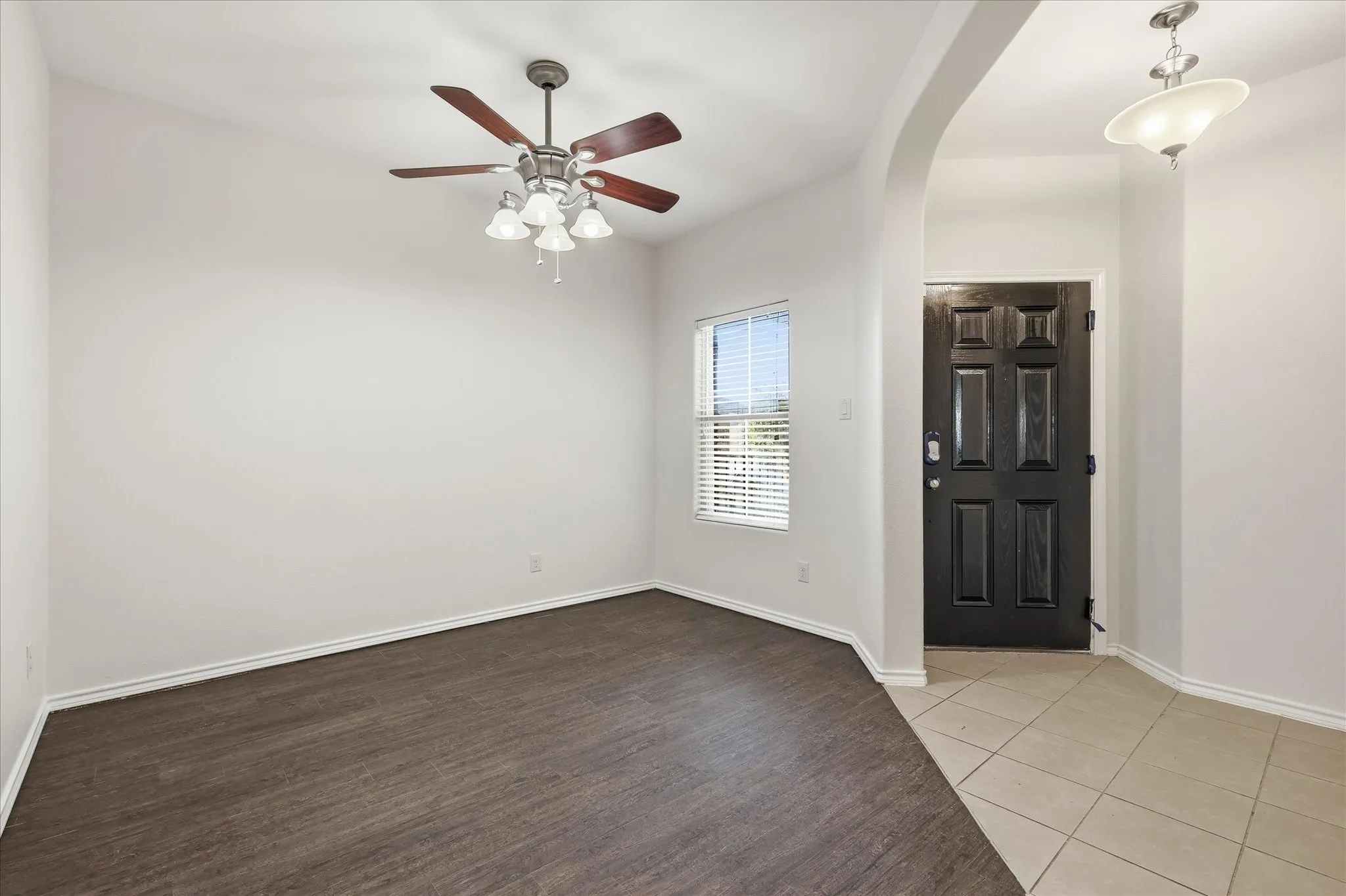 Entryway featuring a dark paneled door and light tile flooring