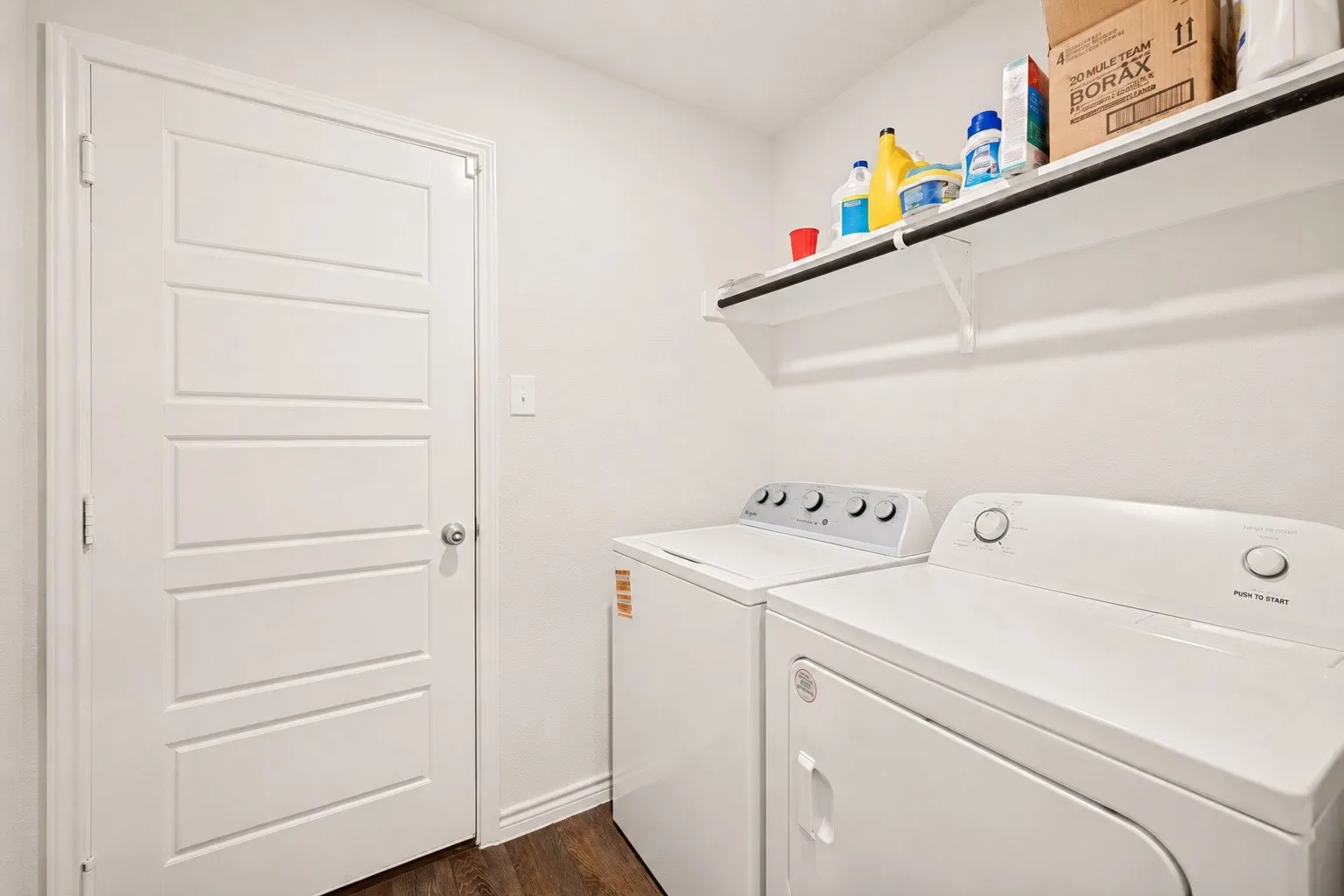 Dedicated laundry area with wood-finish flooring