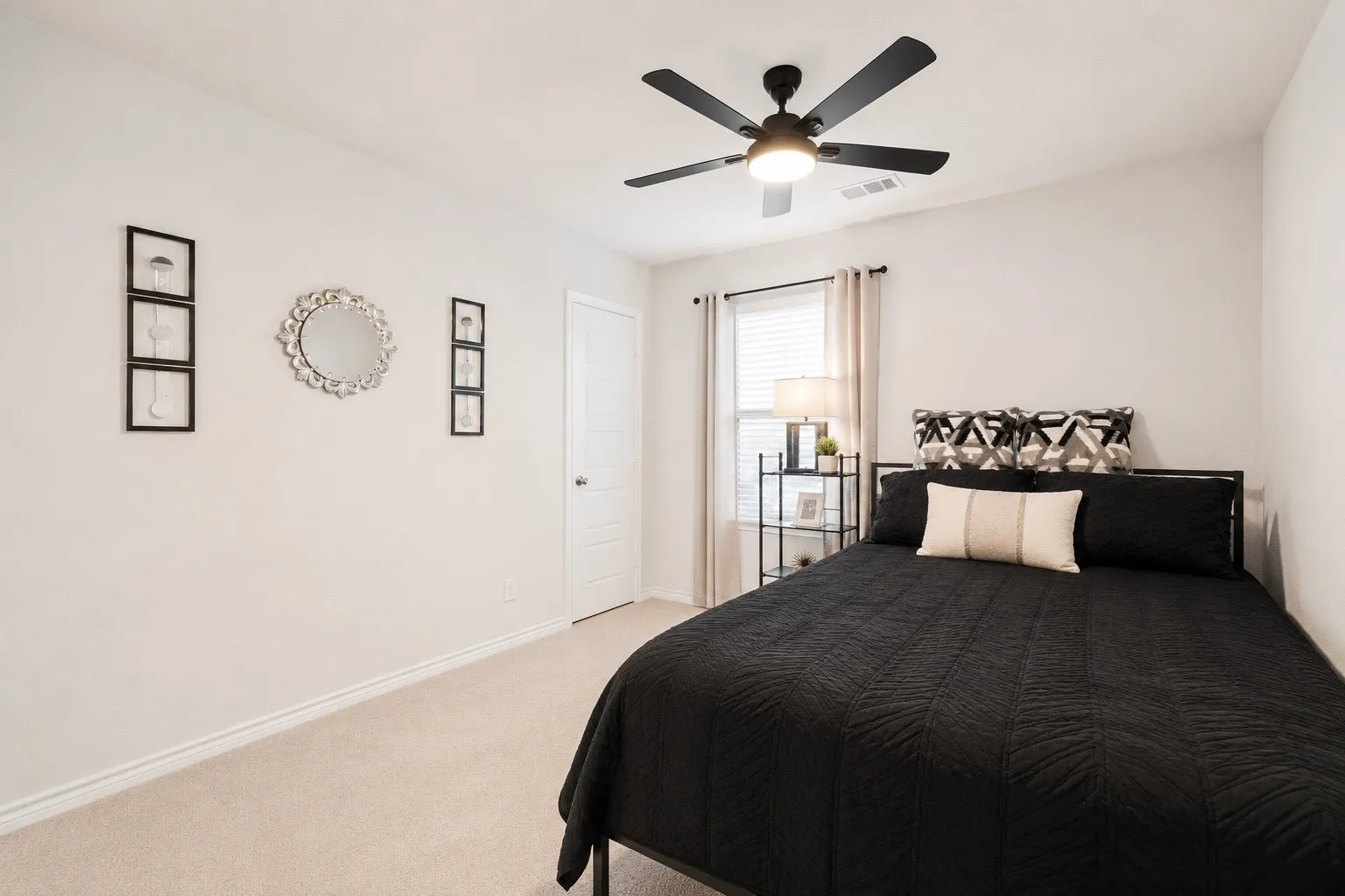 Bedroom featuring light-toned carpeting and neutral wall paint