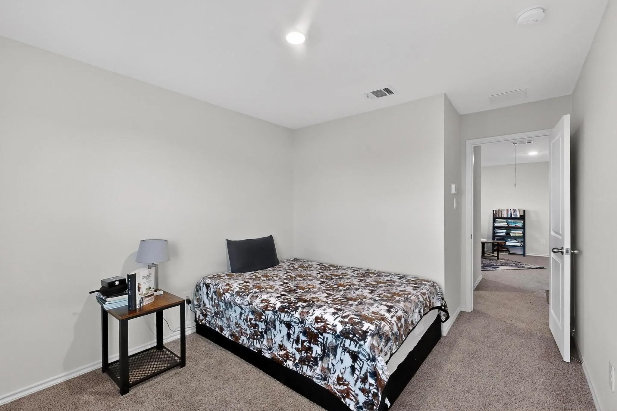 Carpeted room with light neutral walls and recessed lighting