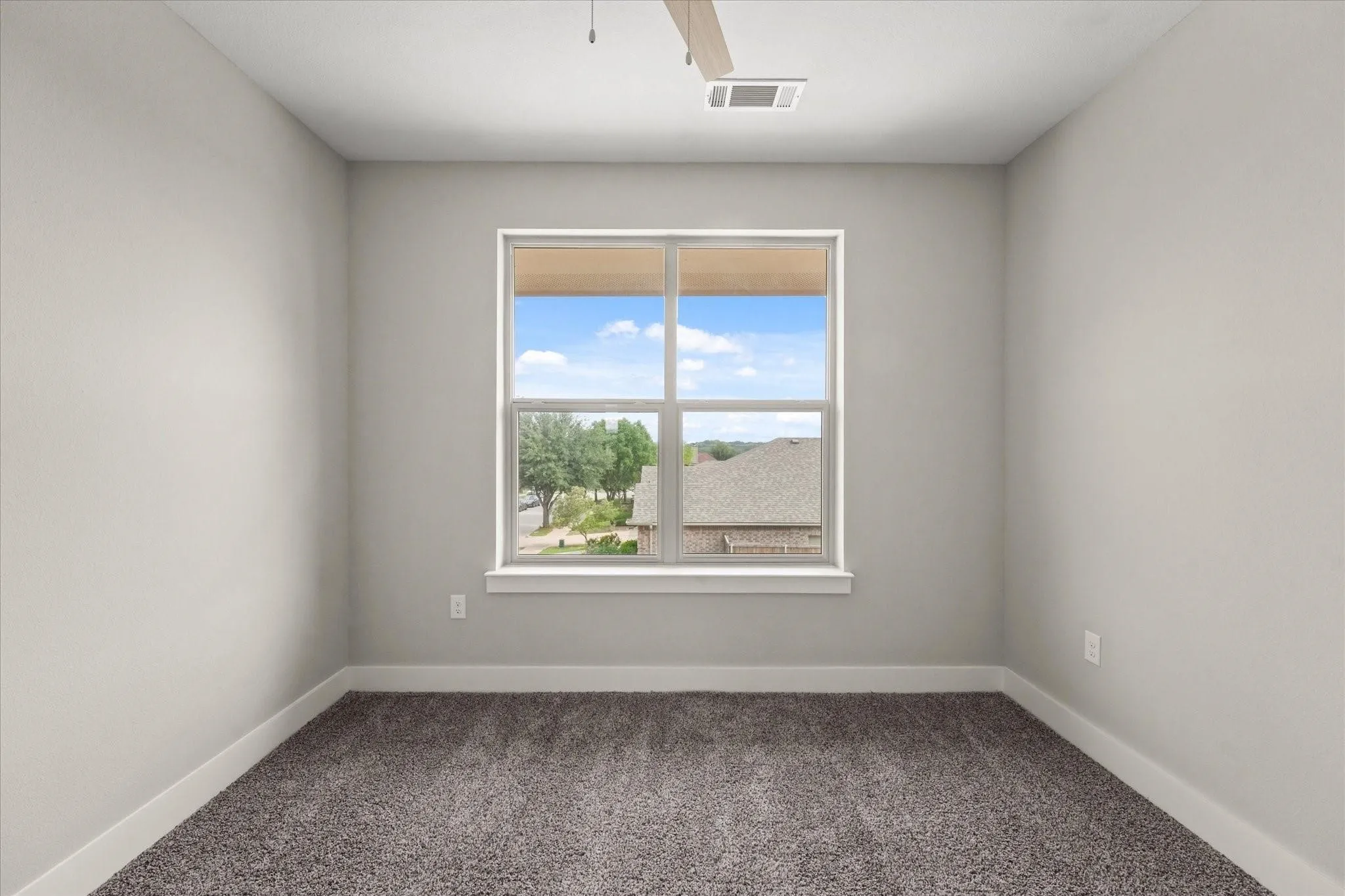 Neutral-toned walls complement the window with white trim, offering natural illumination