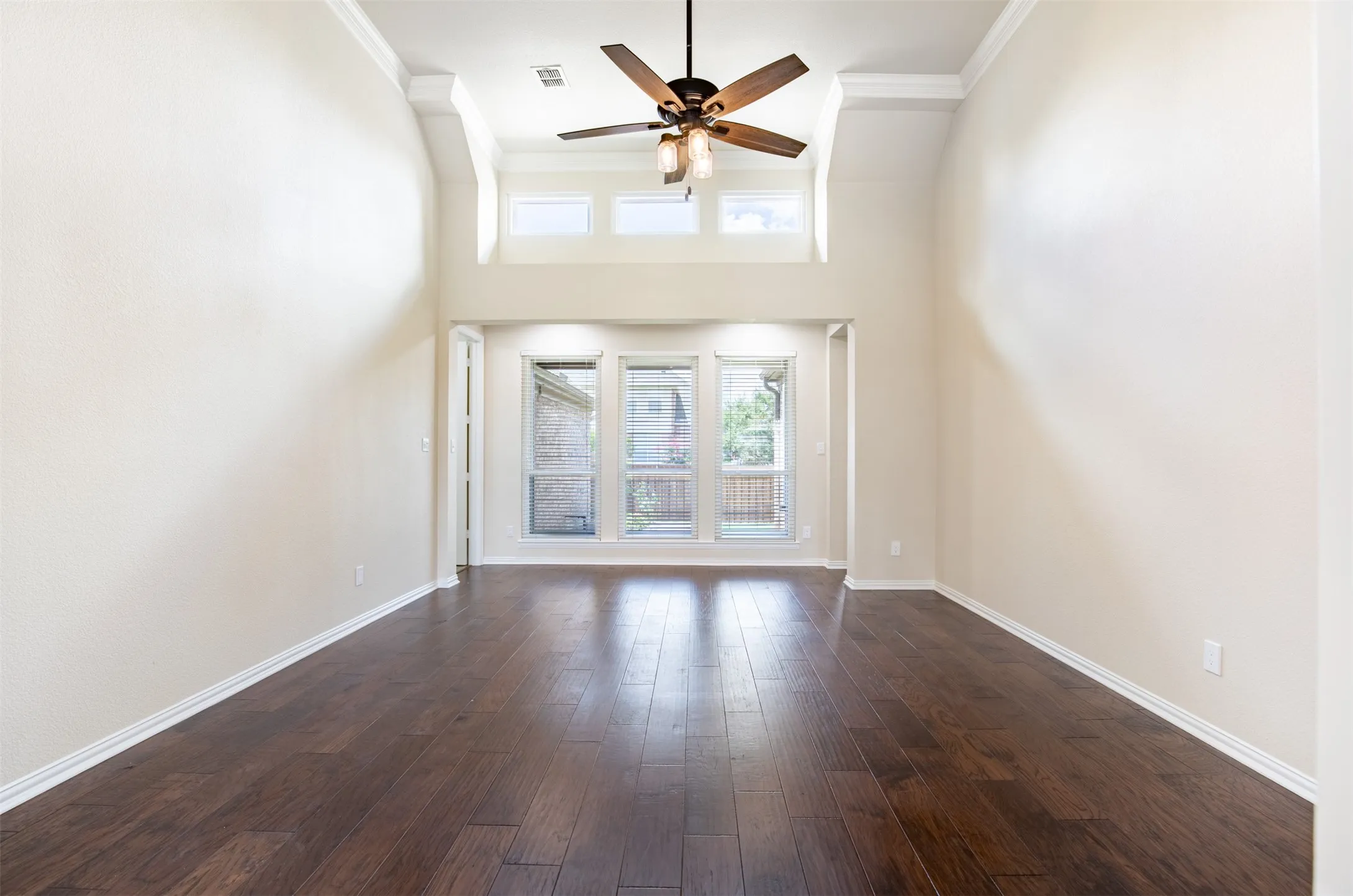 Stunning living room wiht soaring ceilngs and architectural detailing.