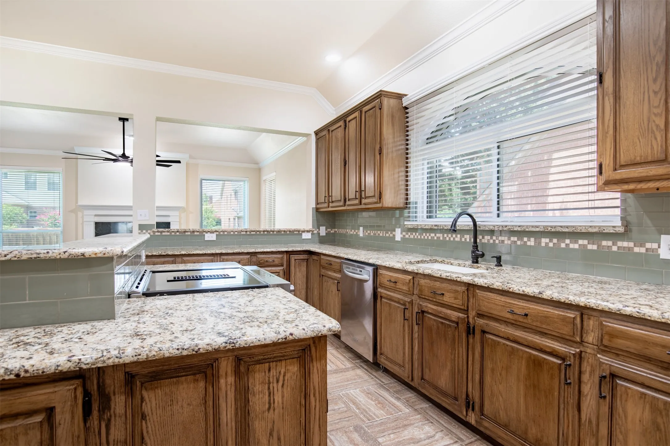 Kitchen with granite countertops and large island with bar top.