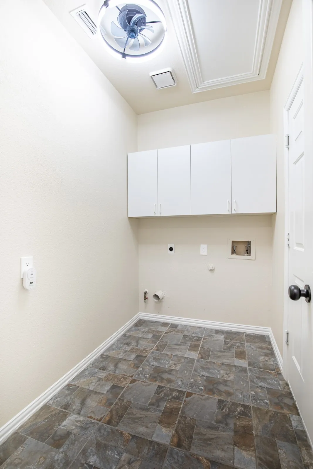 Laundry room with built-in cabinetry.