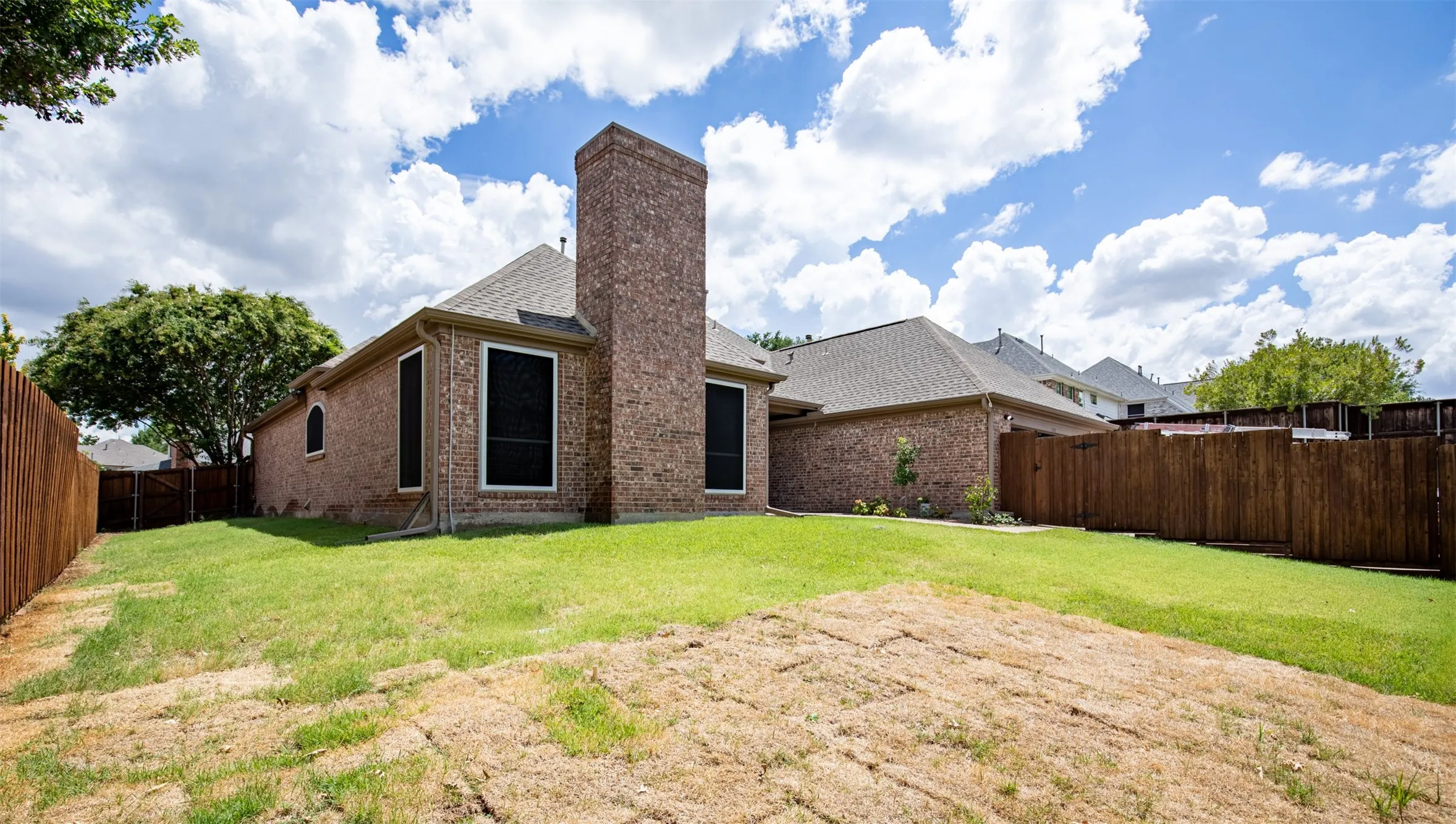Backyard surrounded by privacy fencing.