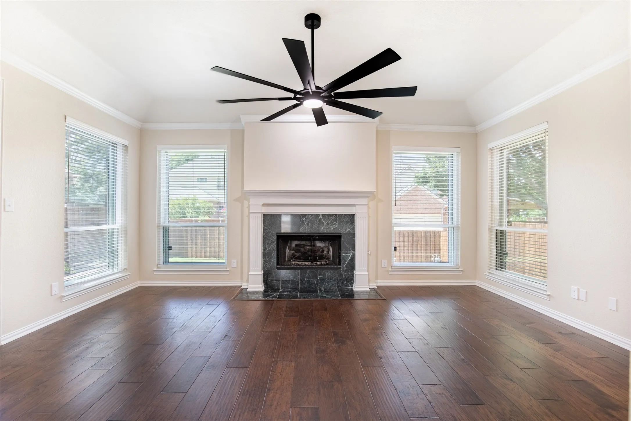 Living room anchored by a cozy fireplace with marble​​‌​​​​‌​​‌‌​‌‌​​​‌‌​‌​‌​‌​​​‌​​ surround.