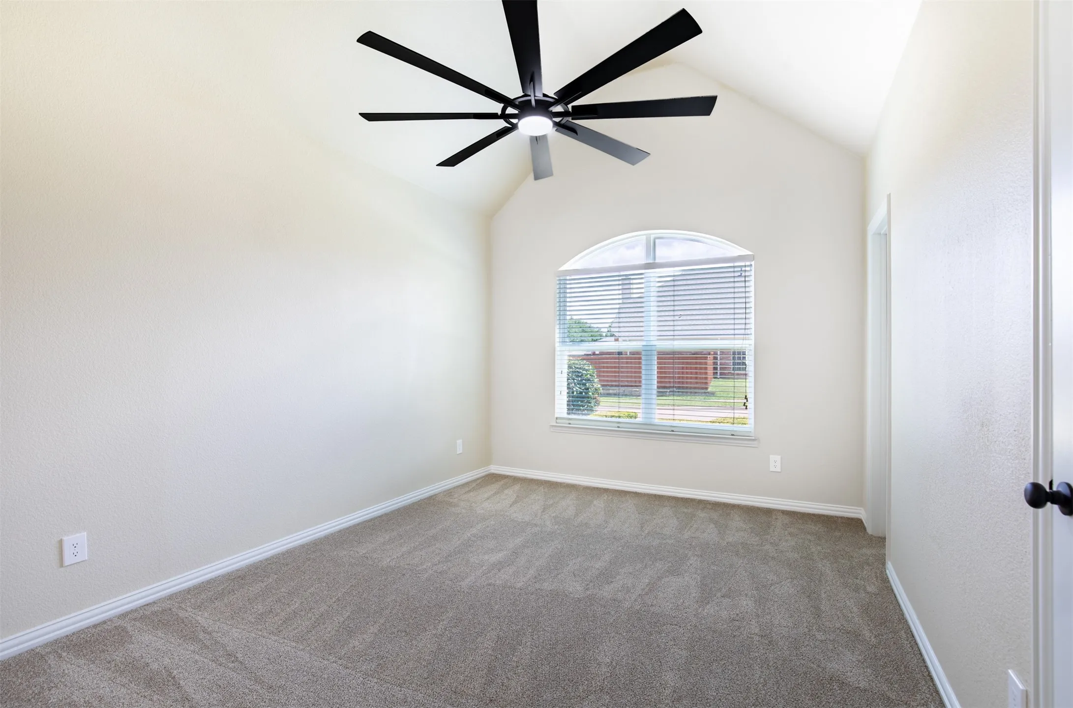 Secondary bedroom with vaulted ceiling and jack and jill bath.