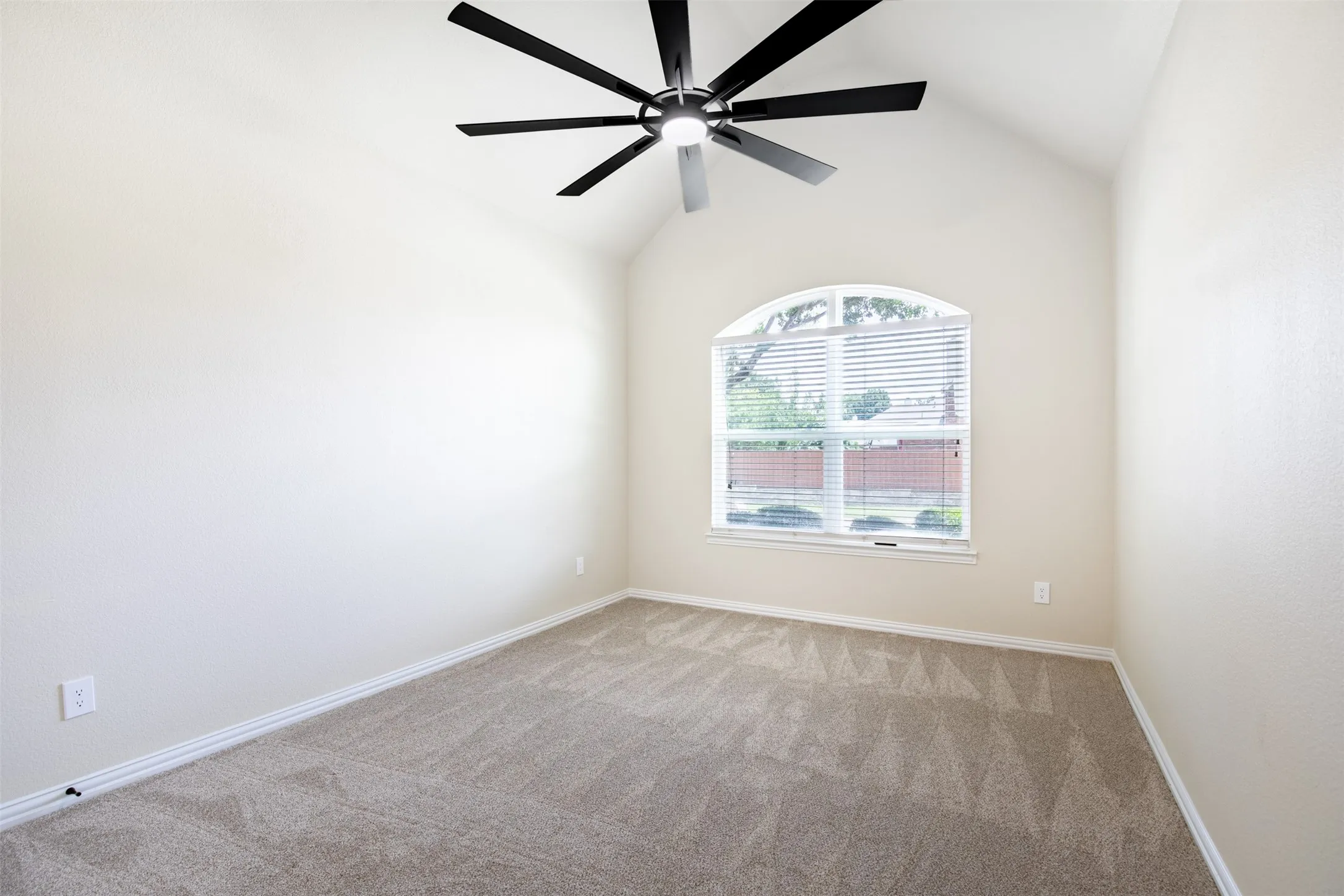 Secondary bedroom with vaulted ceiling.