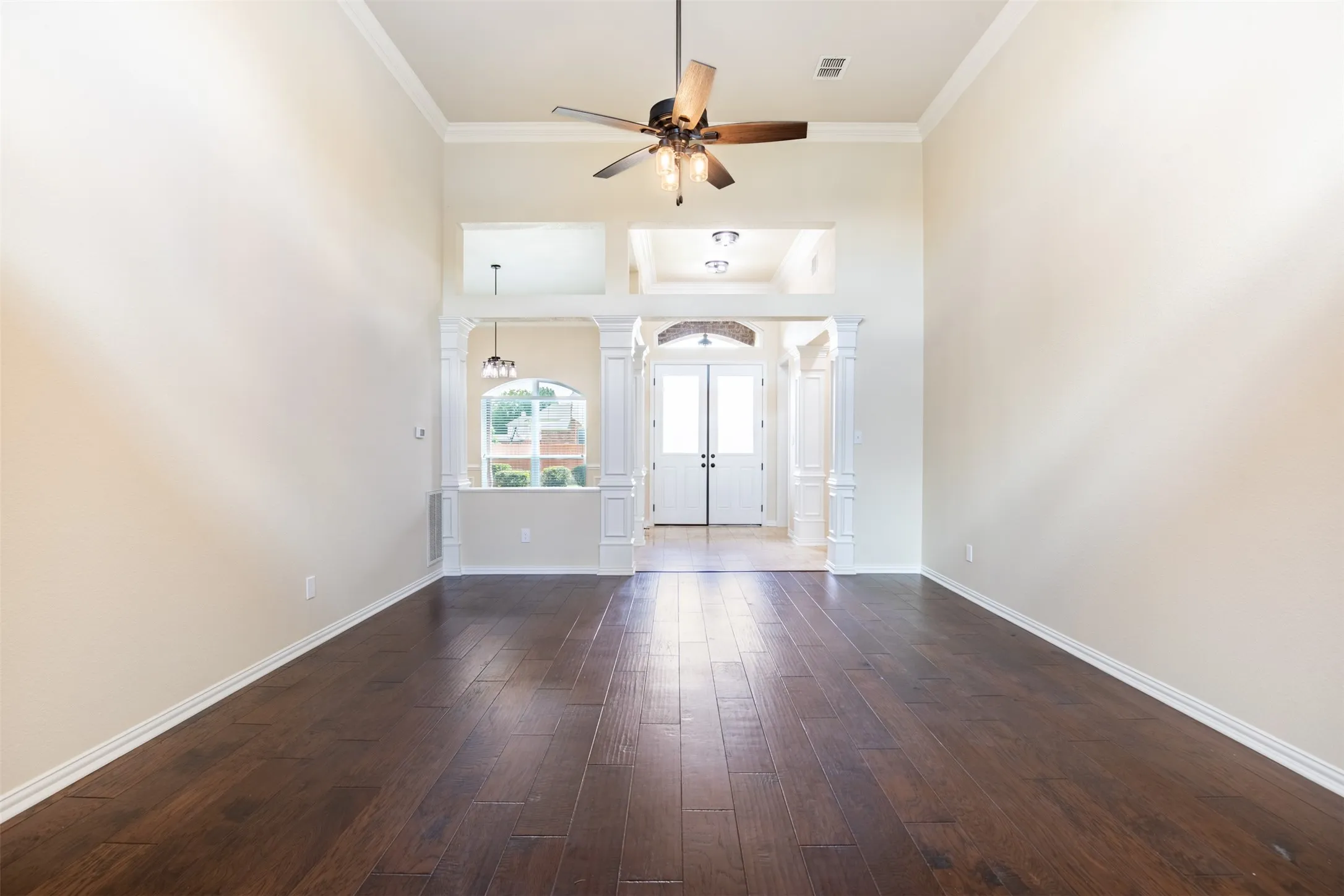 Spacious living room with rich wood flooring.