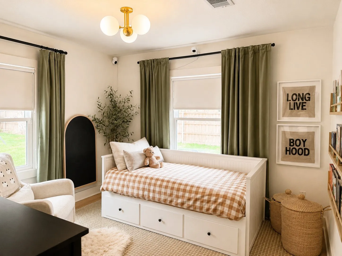 Room featuring a gold-finish semi-flush mount light fixture, two windows, and textured carpeting