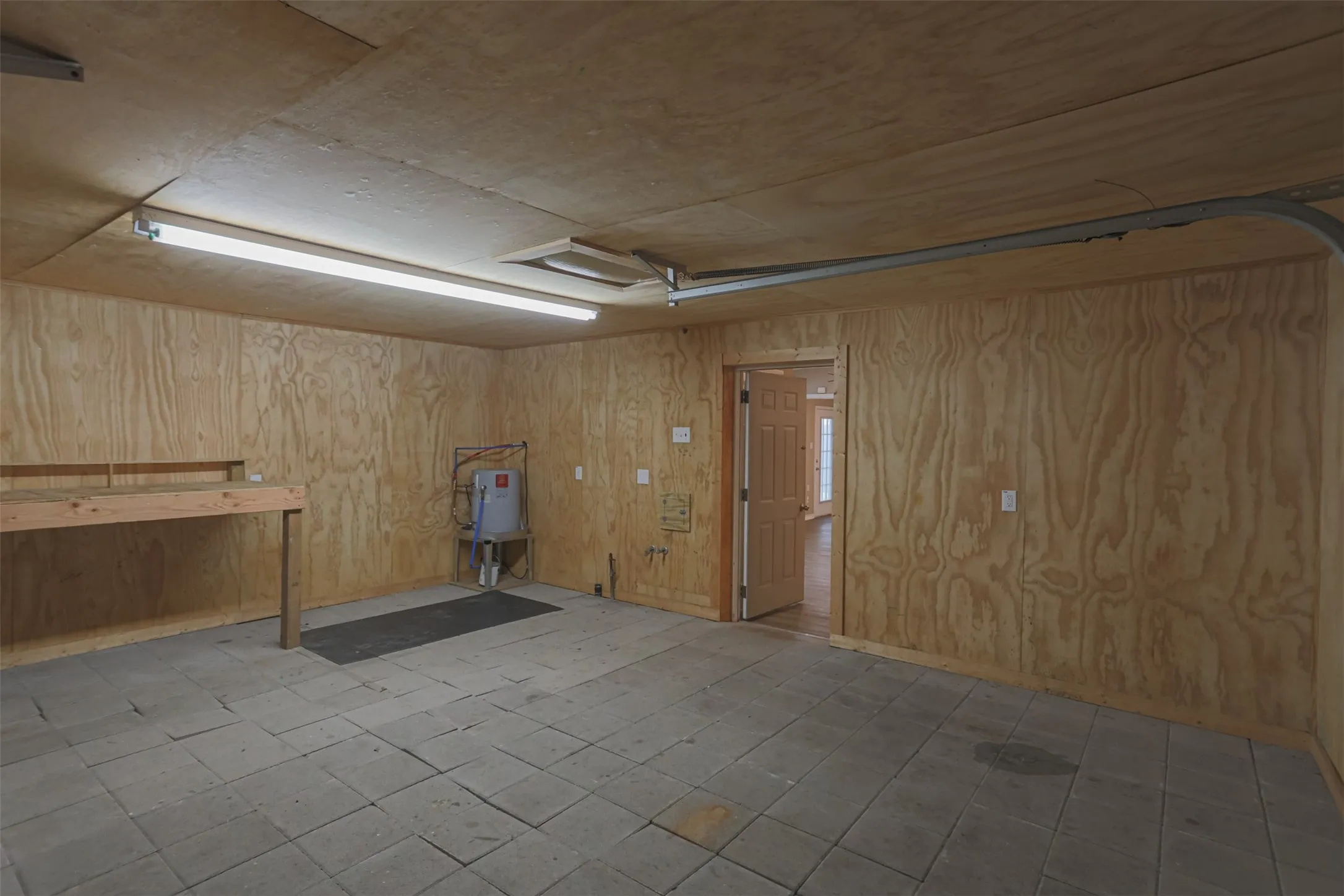 Spacious attached garage offering room for vehicles, storage, or workshop space.