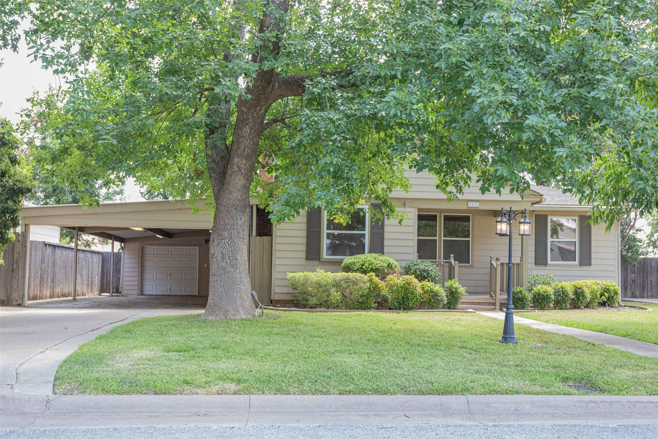 Well-maintained front lawn with mature landscaping and inviting curb appeal.