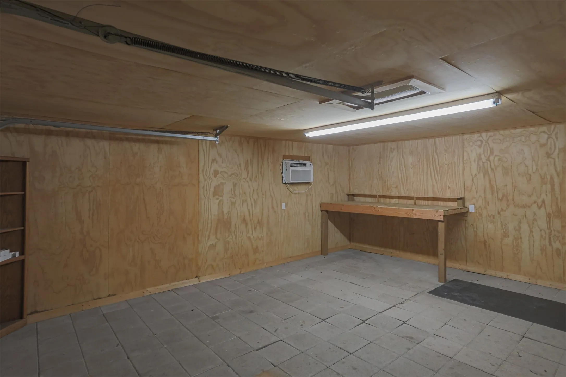 Spacious attached garage offering room for vehicles, storage, or workshop space.