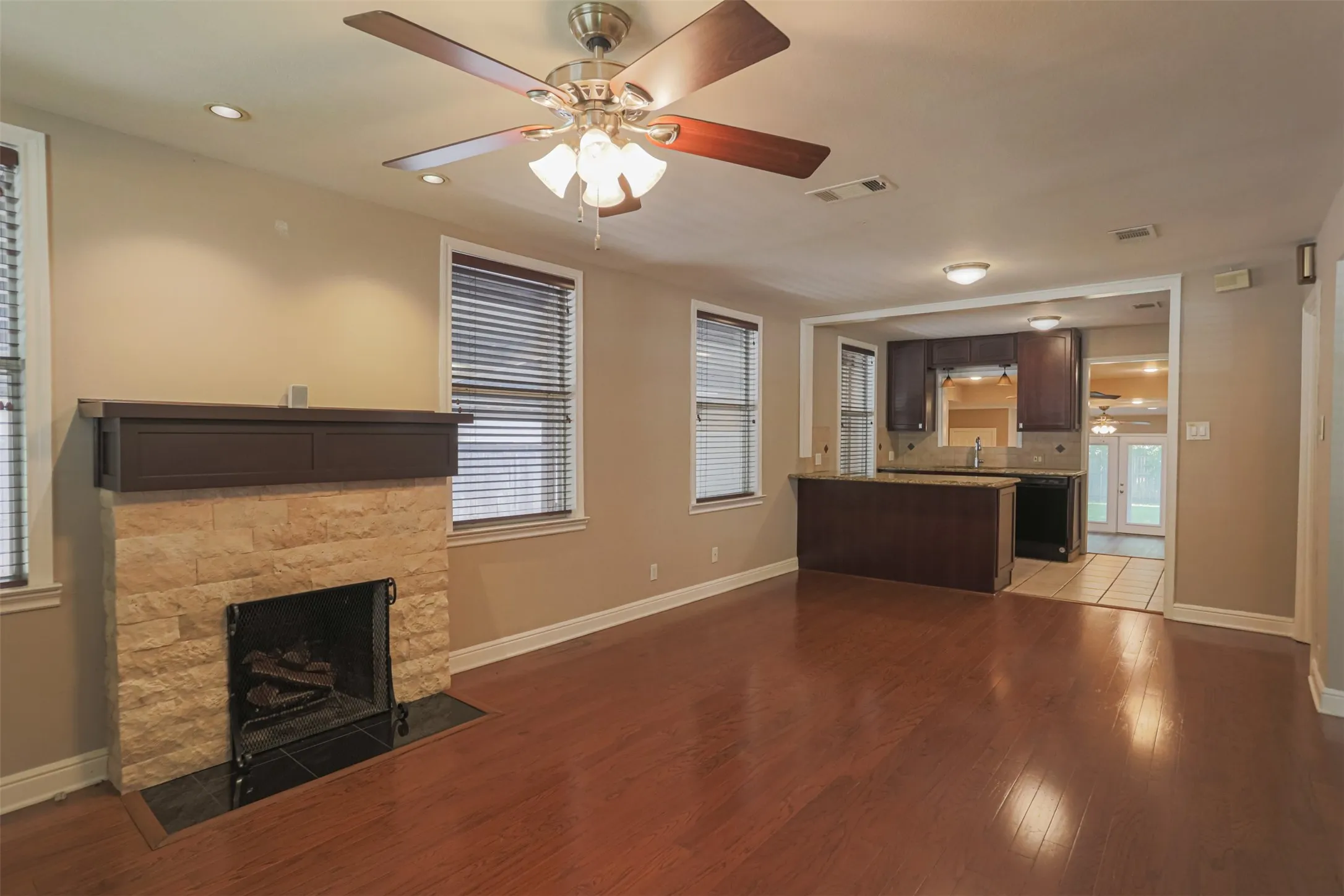 Inviting living room featuring a cozy fireplace and seamless flow into the adjoining living spaces.