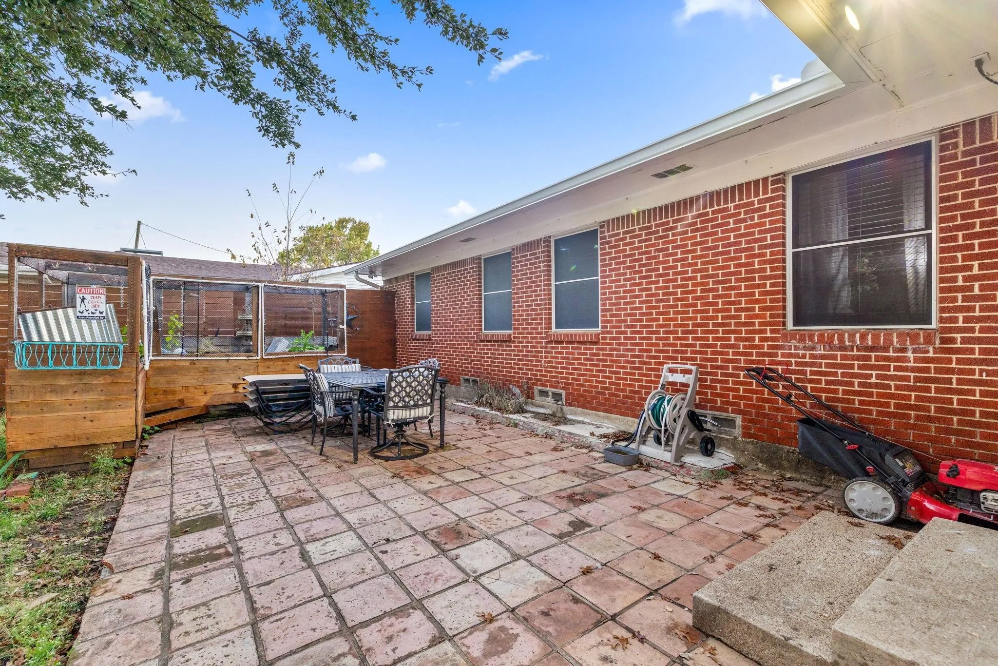 Brick exterior featuring multiple windows with screens