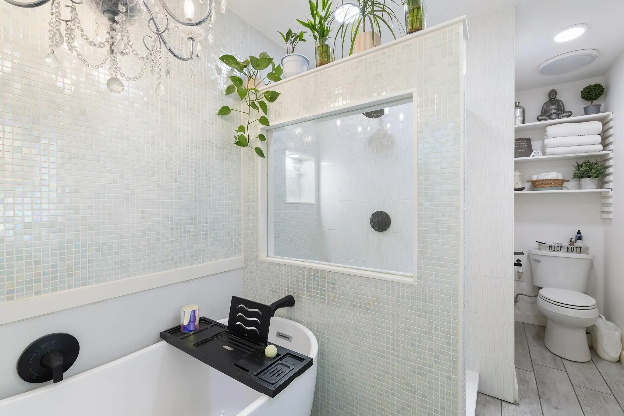 Primary Freestanding tub with matte black fixtures, featuring a crystal chandelier