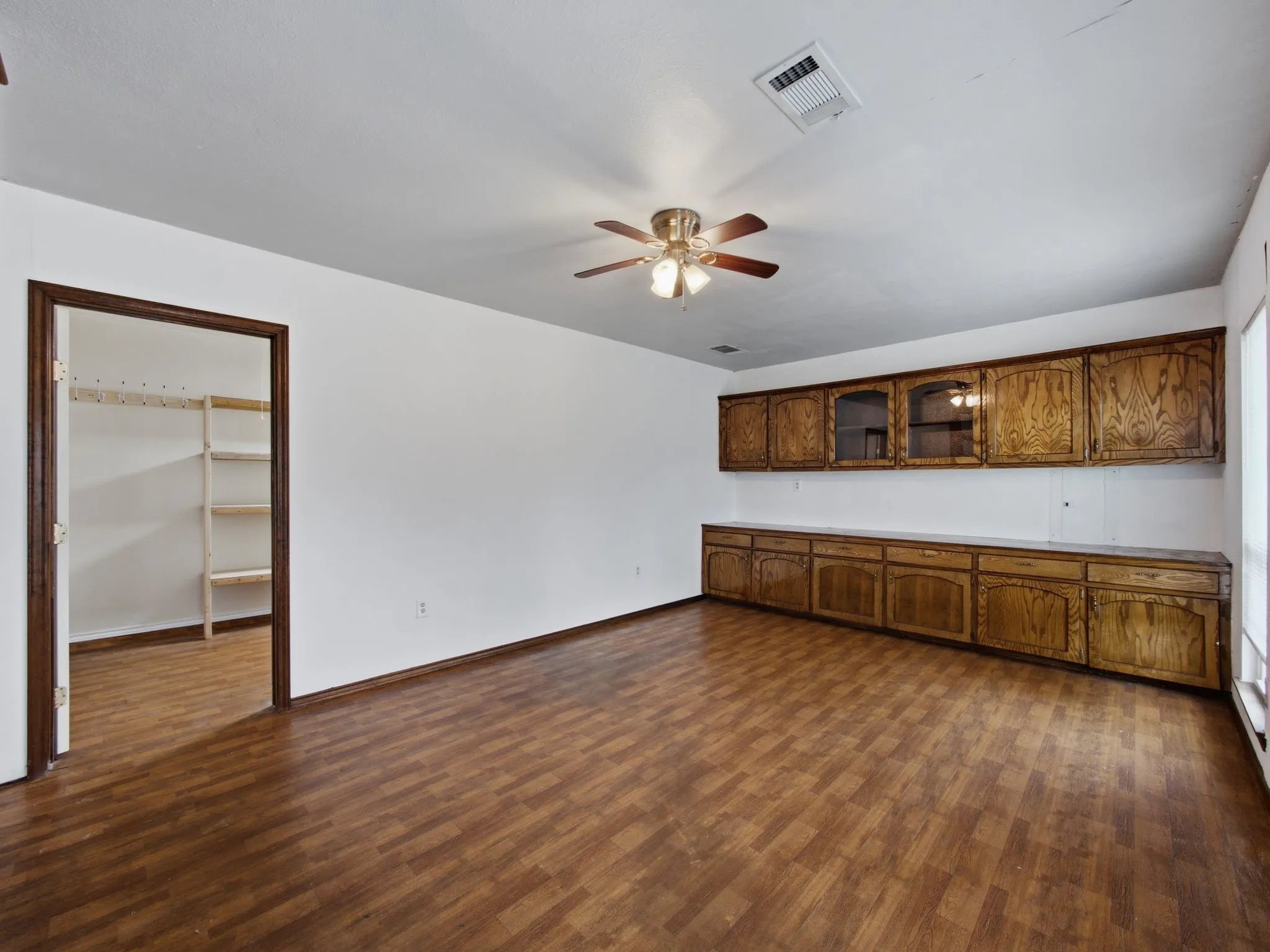 Oversized laundry room with built in cabinets