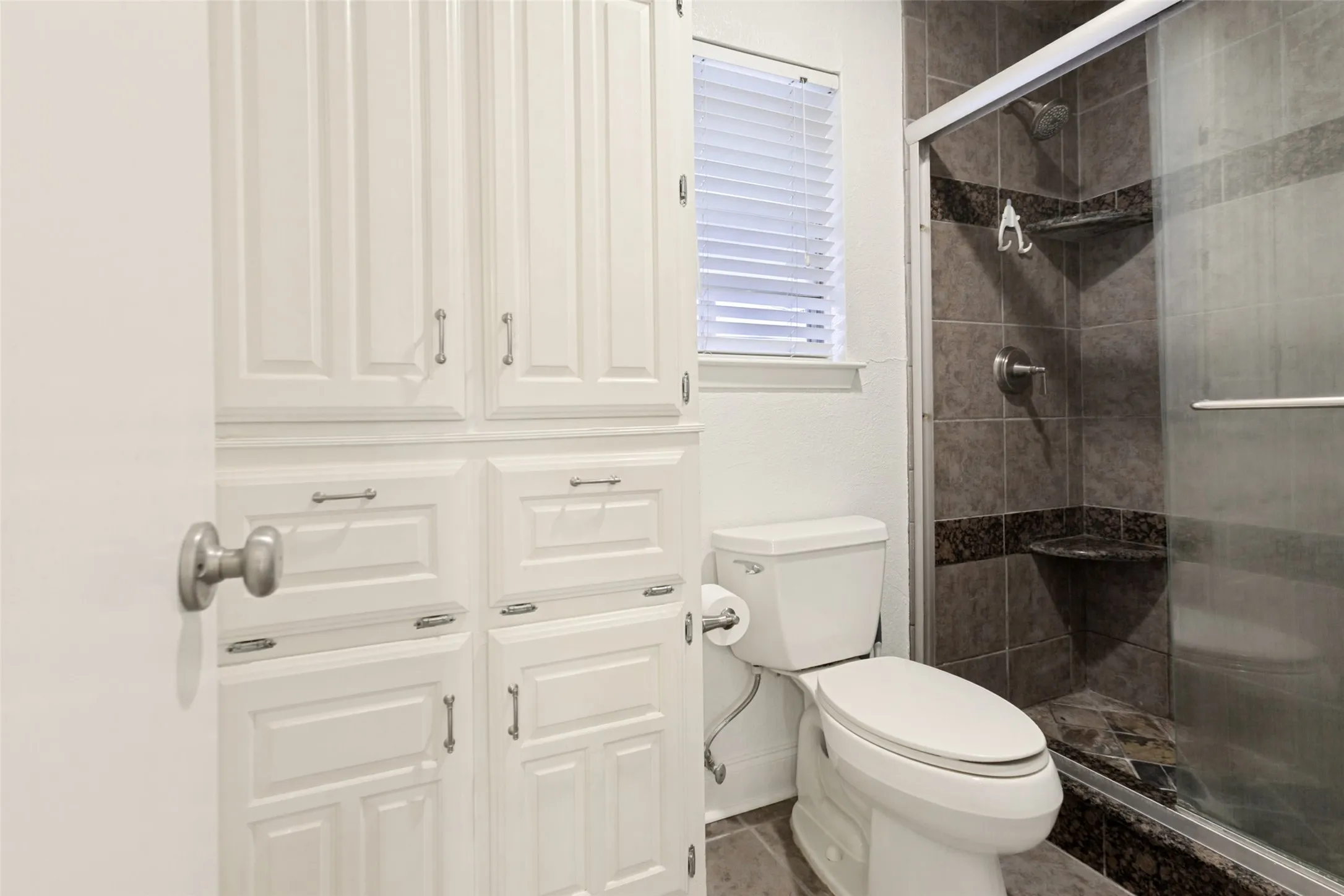 White built-in cabinetry provides extensive storage