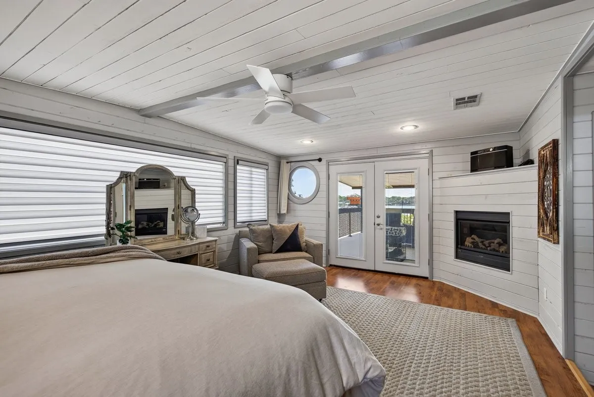 The primary suite is complete with birds eye lake views as well as a cozy fireplace for winter!