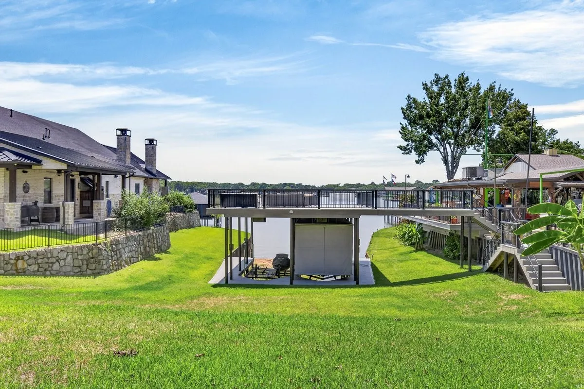 The boat dock selling with the home is the side with the touchless cover. Seller owns the connecting lot and will retain other half of boathouse.