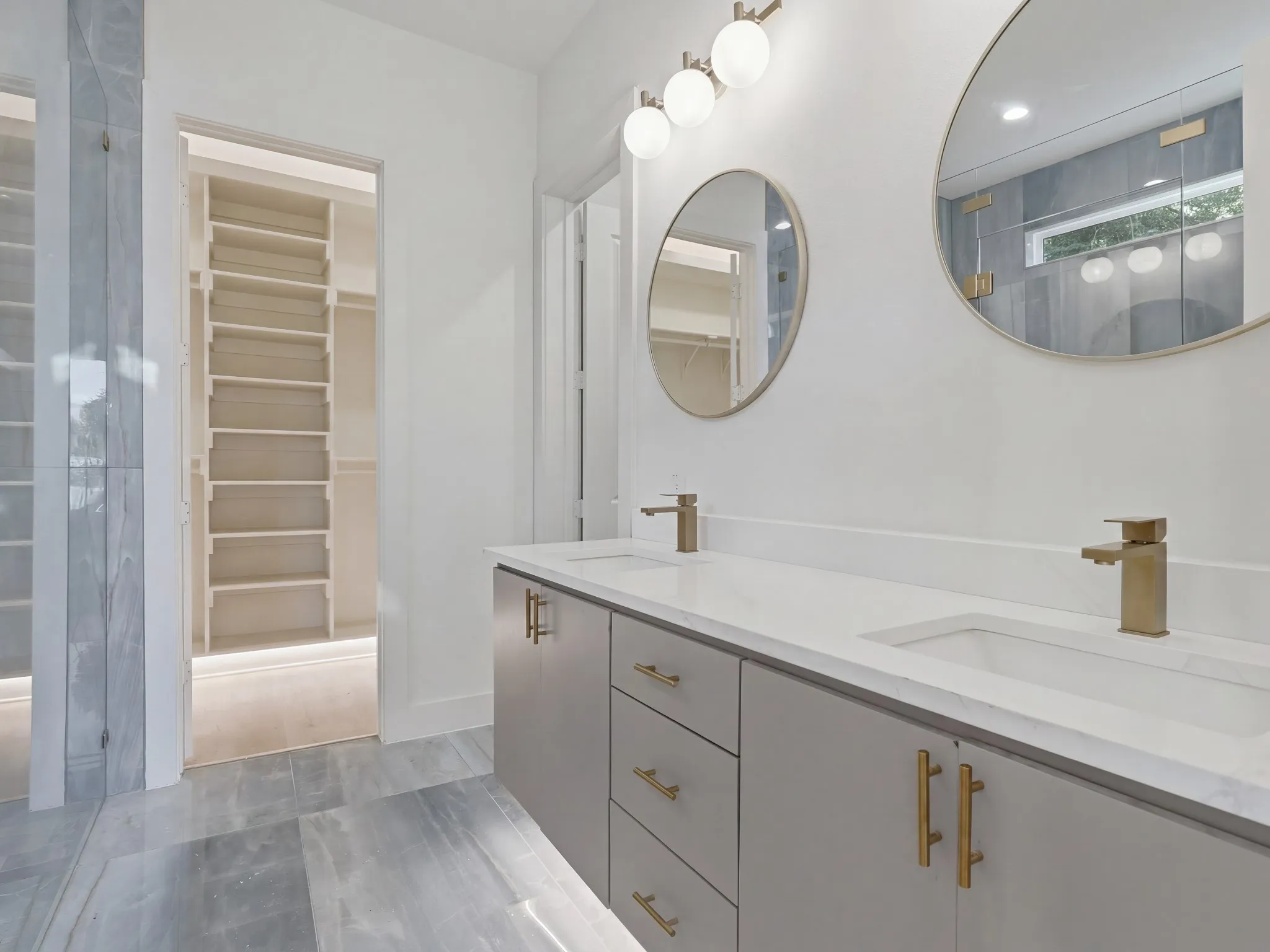 Dual vanity with quartz countertop, undermount sinks, and brushed gold fixtures