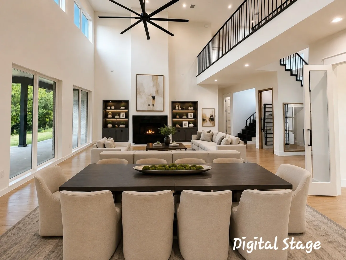 Spacious living area featuring high ceilings, light wood-finish flooring, and a contemporary fireplace with a dark surround living space featuring high ceilings,