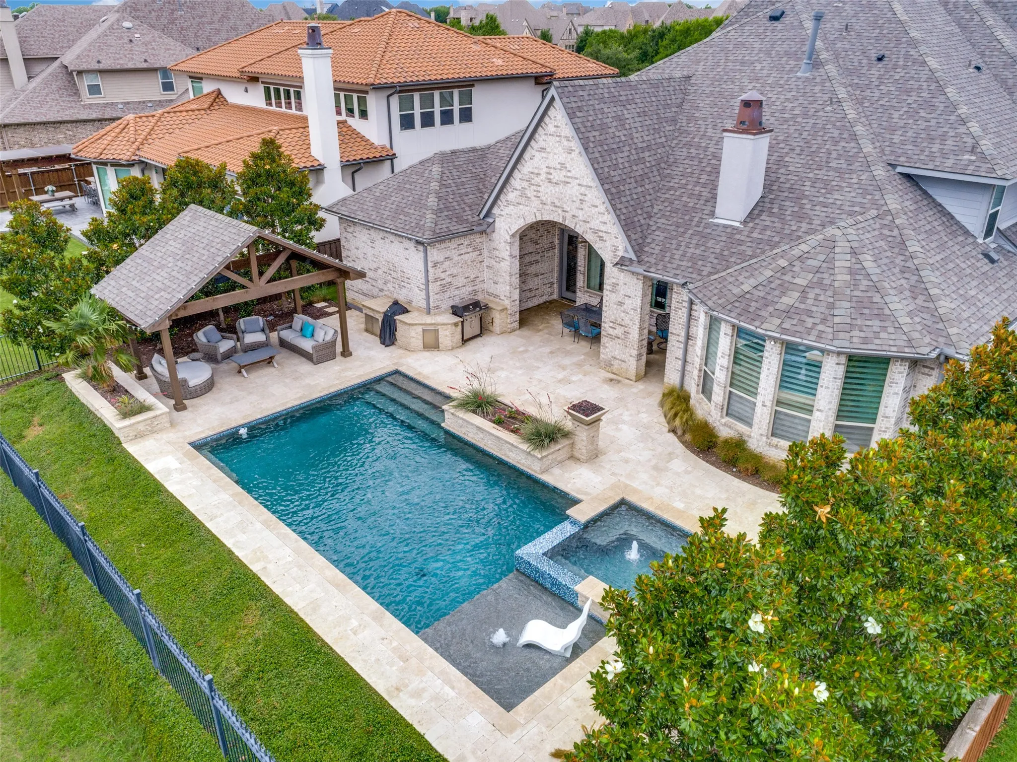 This bird's eye view of the backyard shows the well-planned design for the perfect outdoor setting.  This home has it all...the perfect floorplan, exceptional amenities, quality finishout, premium outdoor additions and a stunning view!