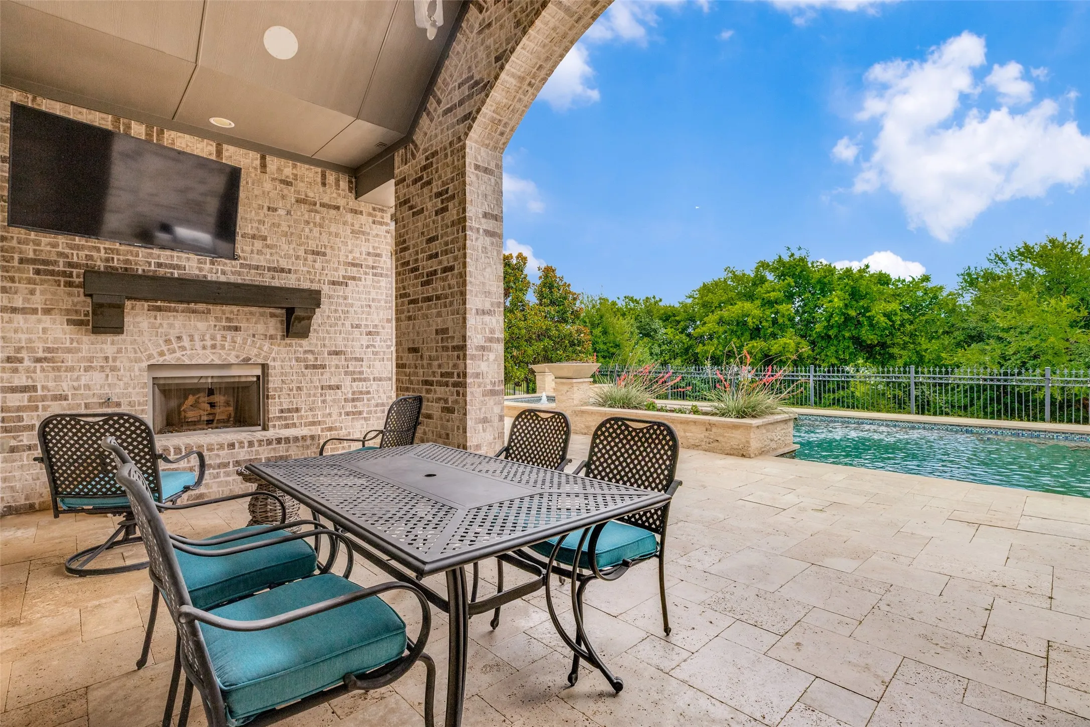 How can you resist this fabulous outdoor resort in your own backyard.  The large covered patio enclosed with a tall brick arch is ideal for al fresco dining!  There is also room for furniture to sit and enjoy a fire on a chilly evening or watch TV.  The space is wired for an outdoor TV and speakers are in the ceiling.