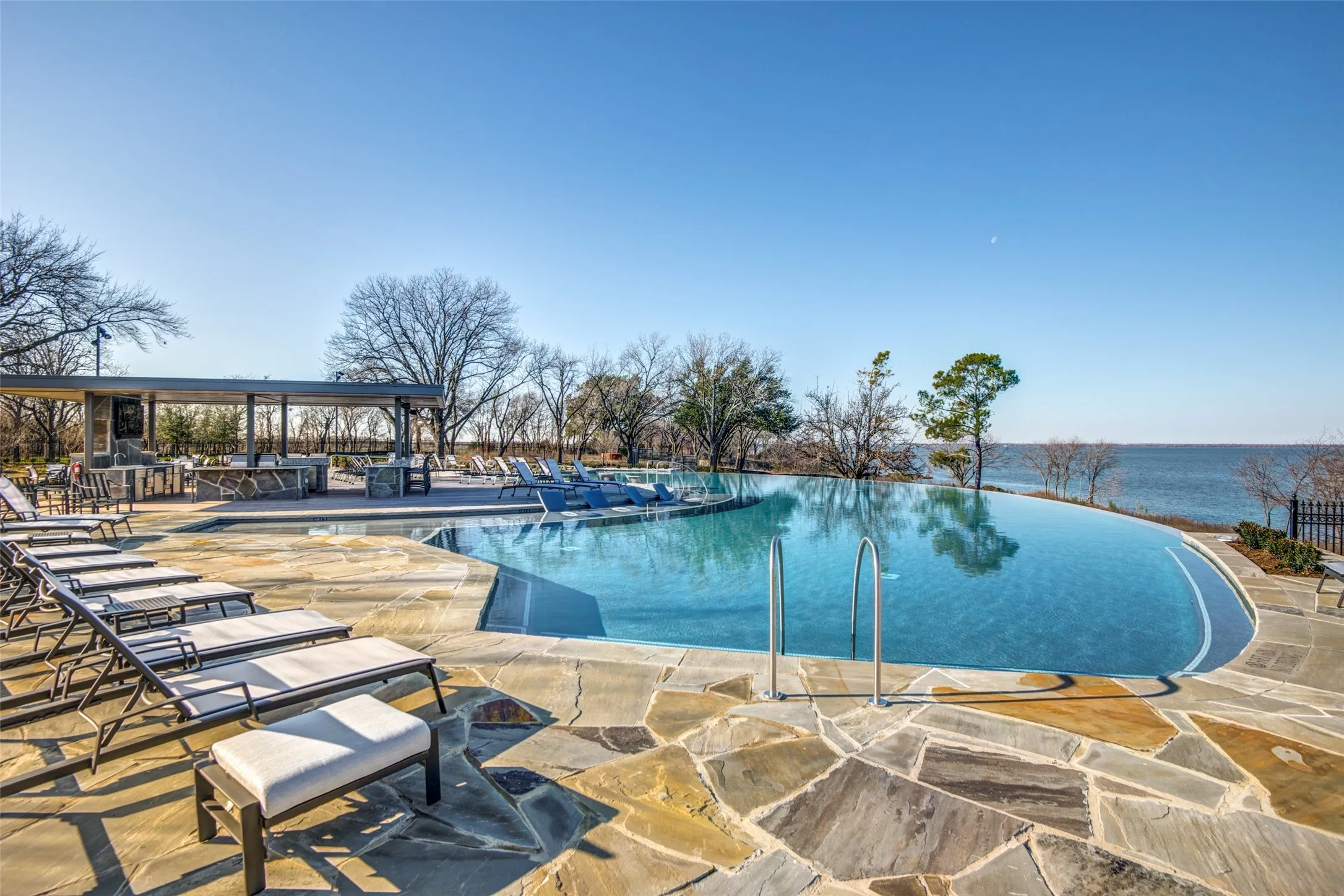 This second pool with an infinity edge allows swimmers to almost "merge" with the lake as the float in the pool.  A terrific outdoor kitchen provides space for outdoor cooking and block-party get togethers.  A third pool in the community is allocated only for use of one specific section.  In addition to water sports and golf, The Tribute offers a wide array of activities including playgrounds, pickleball, dog parks, a kayak and canoe launch, fishing, a variety of types of hiking/jogging trails and, soon, a marina.
