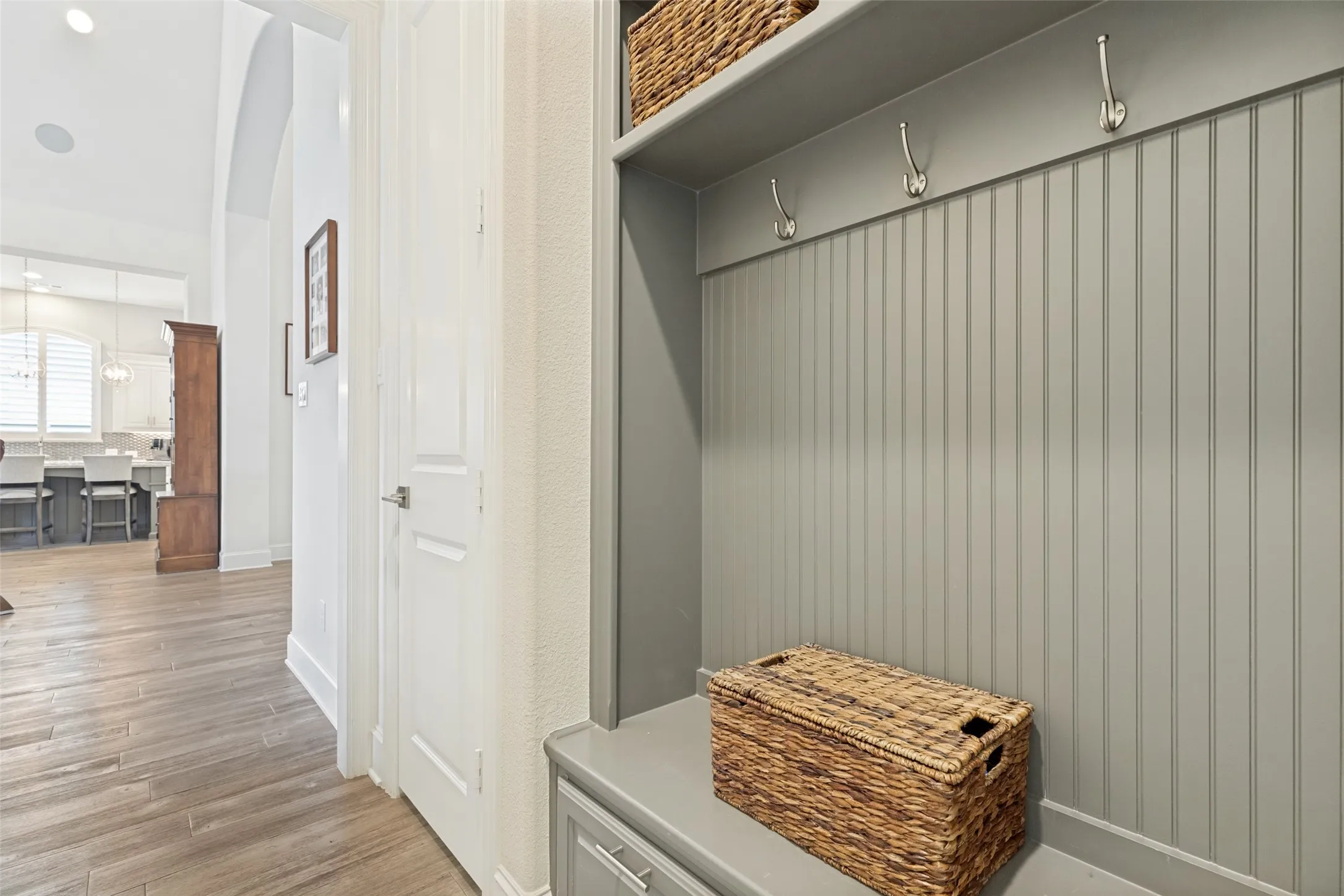 A handy mud bench with cubbies and drawers is in the hallway leading to the garage.  A door opens to a huge storage area under the stairs.  Across the hall is the utility room with upper and lower cabinets on one side and upper cabinets above the washer/dryer area on the other.  Eight foot solid core doors are downstairs.