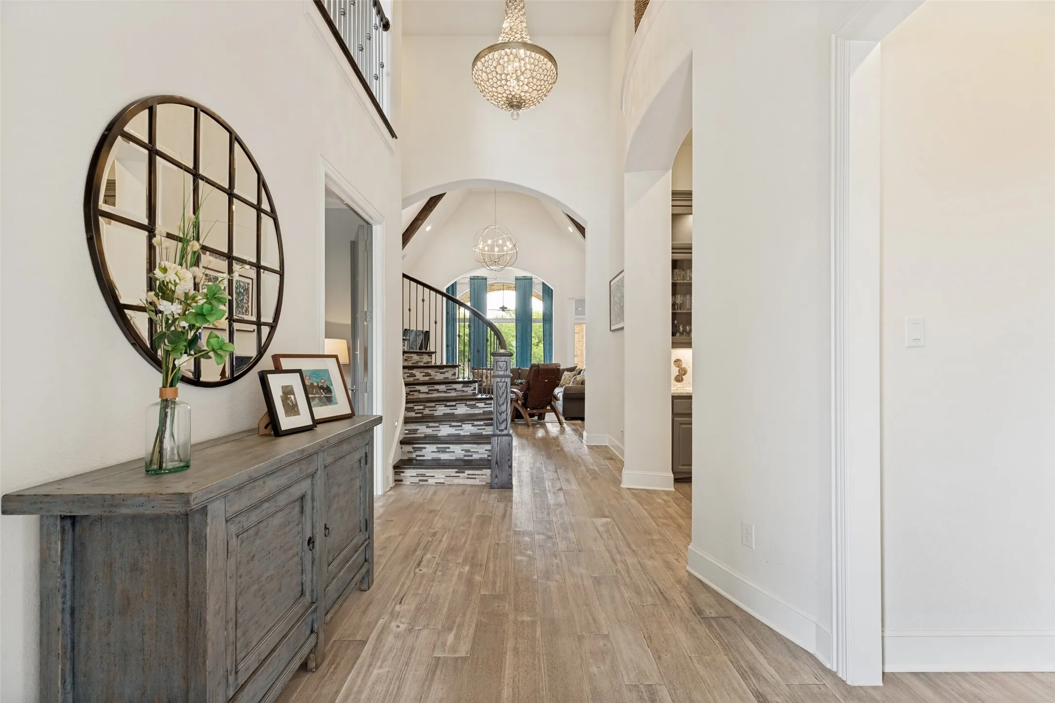 No scuff marks on these stairs...instead of paint, there is durable decorative tile on the risers.  The foyer extends into the home with overlooks from above.  A beautiful chandelier hangs above.