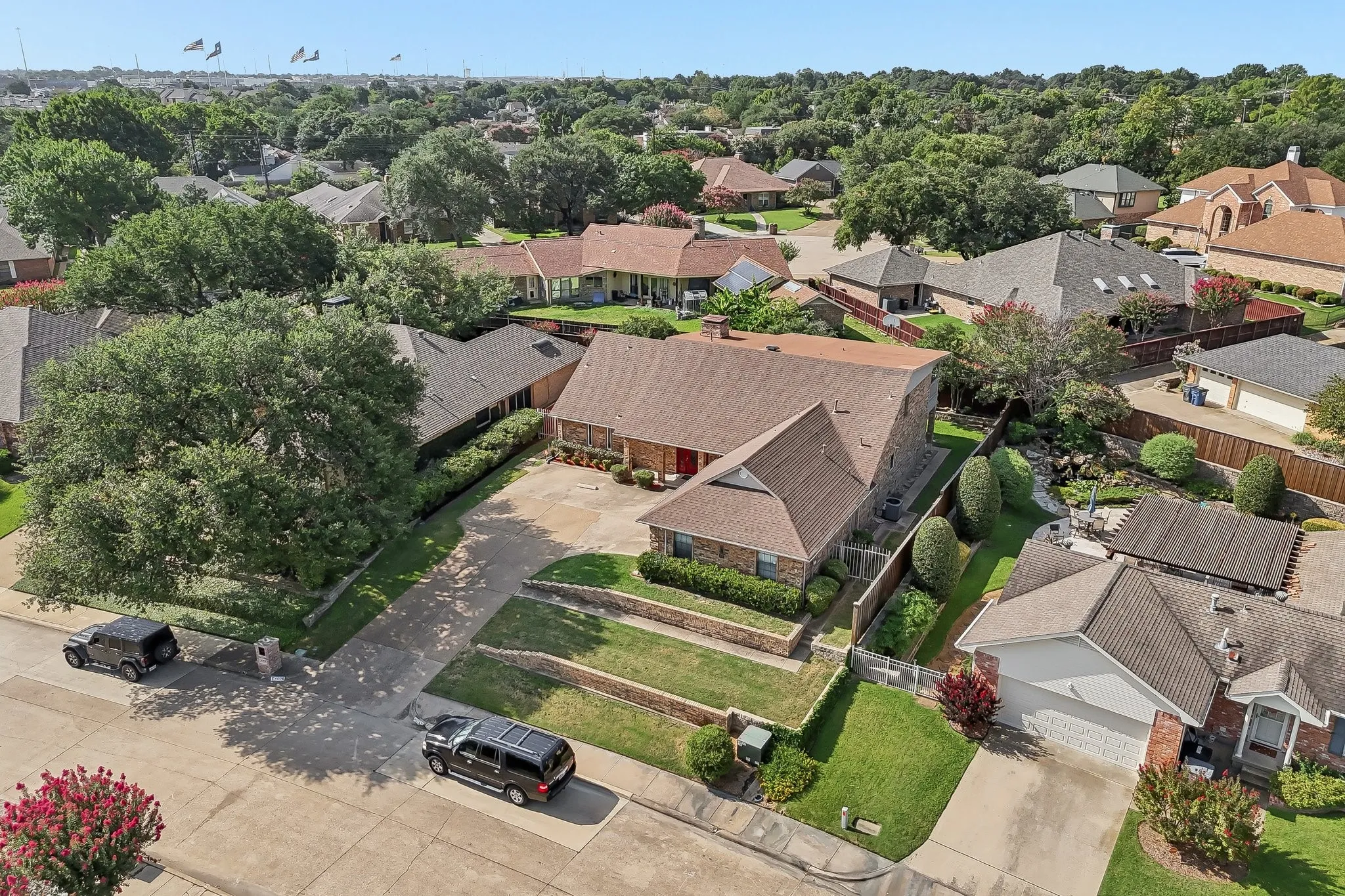 Residential property featuring a shingle roof and brick exterior