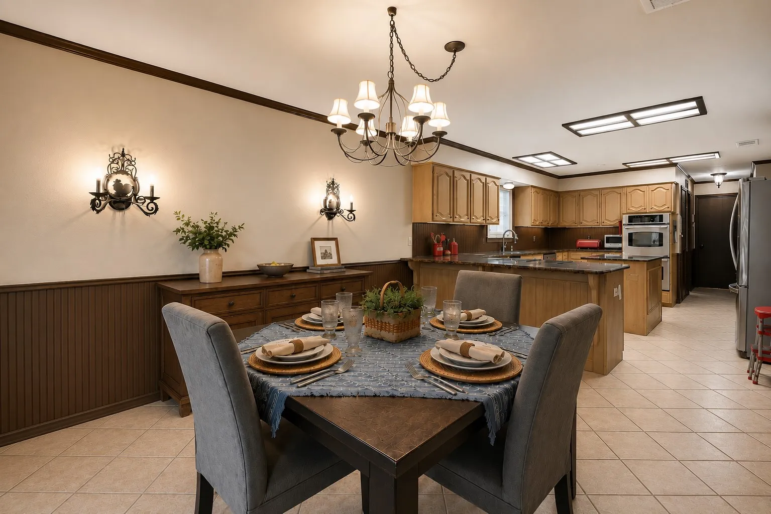 Dining area featuring a chandelier, wall sconces, and beadboard paneling