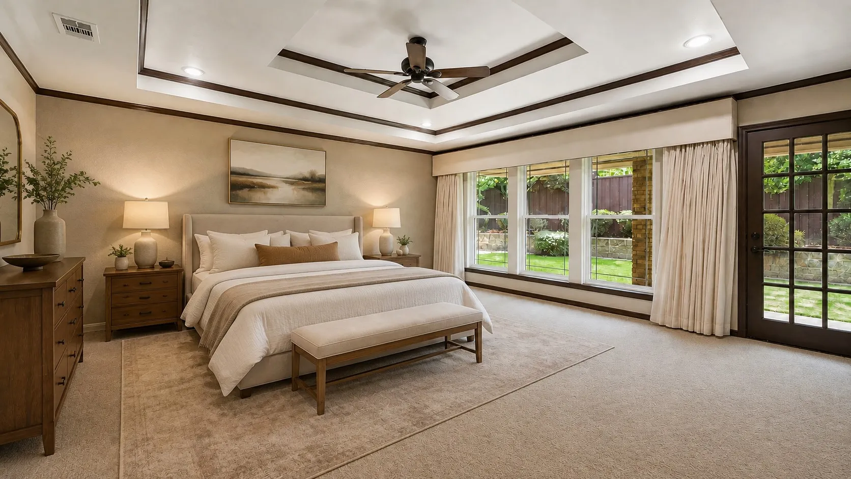 Tray ceiling with recessed lighting and ceiling fan, wood-trim details, wall of windows, glass-paneled door, and carpet flooring